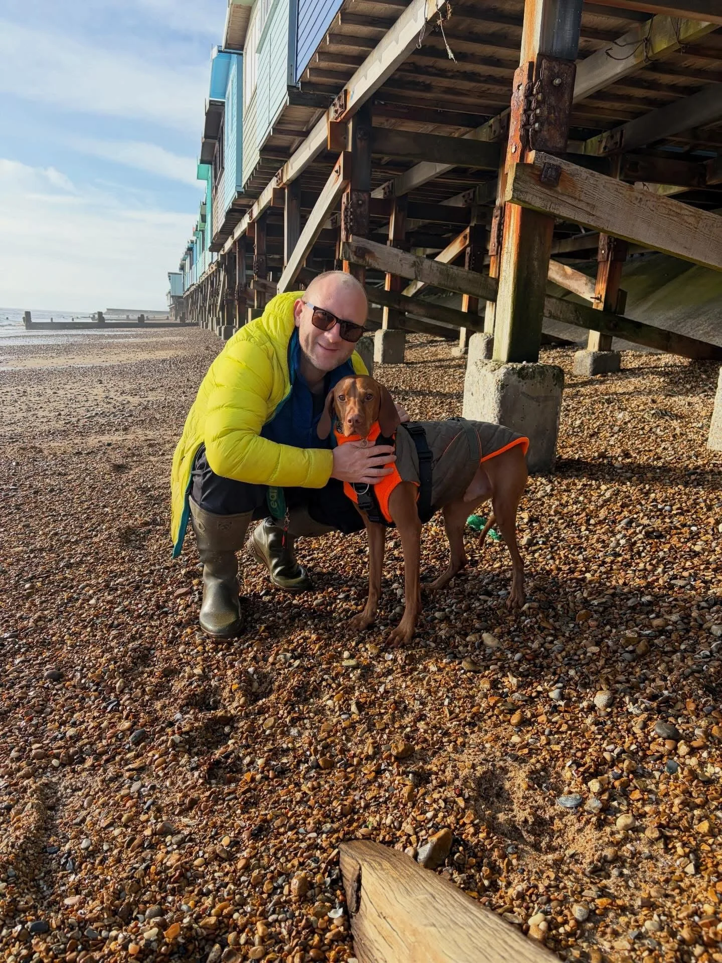 Dave posing with his own vizsla on a beach in Essex