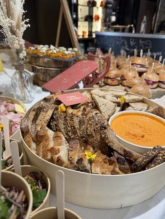 buffet avec différents plats genre houmous et bouchées pour un séminaire d'entreprise et carte de visite Native Cameline