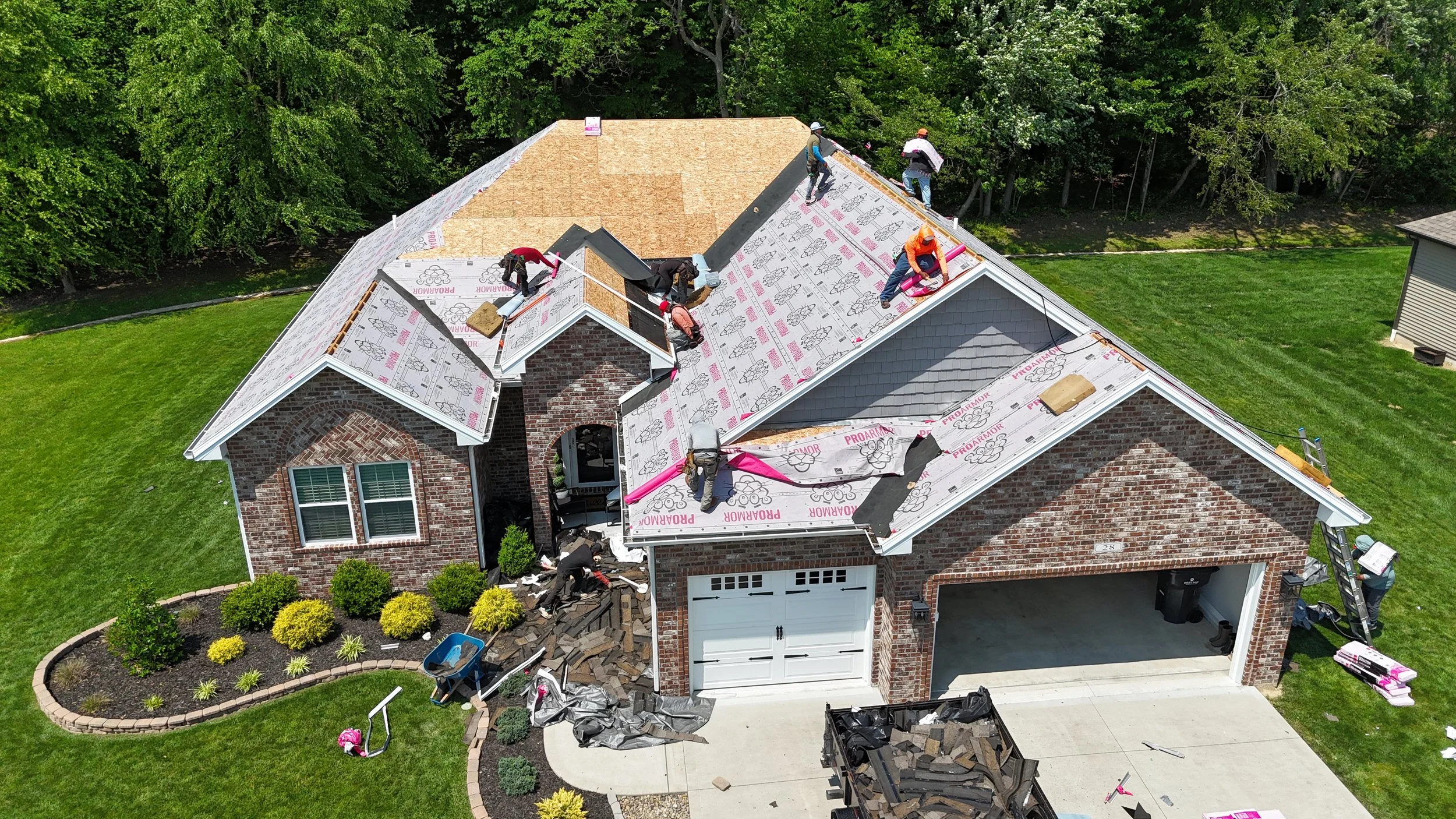 Residential roof replacement in progress with shingle installation in Madison Indiana