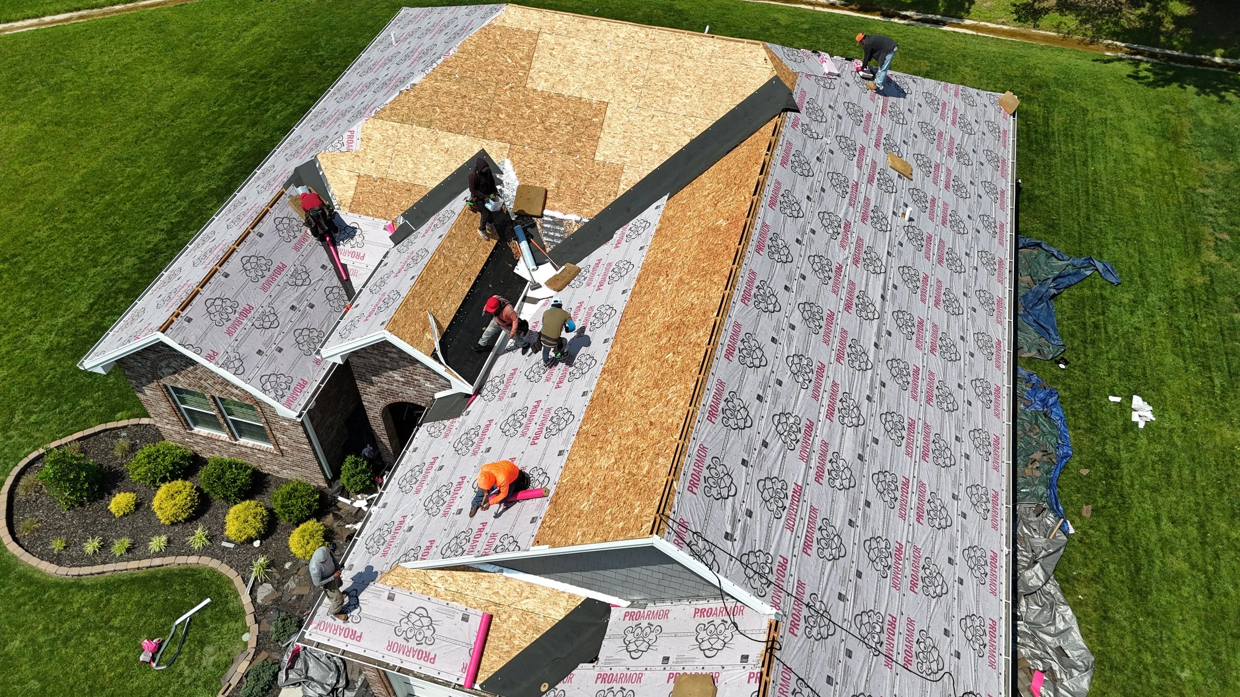 New roofing system installation with underlayment and shingle preparation in Hanover Indiana