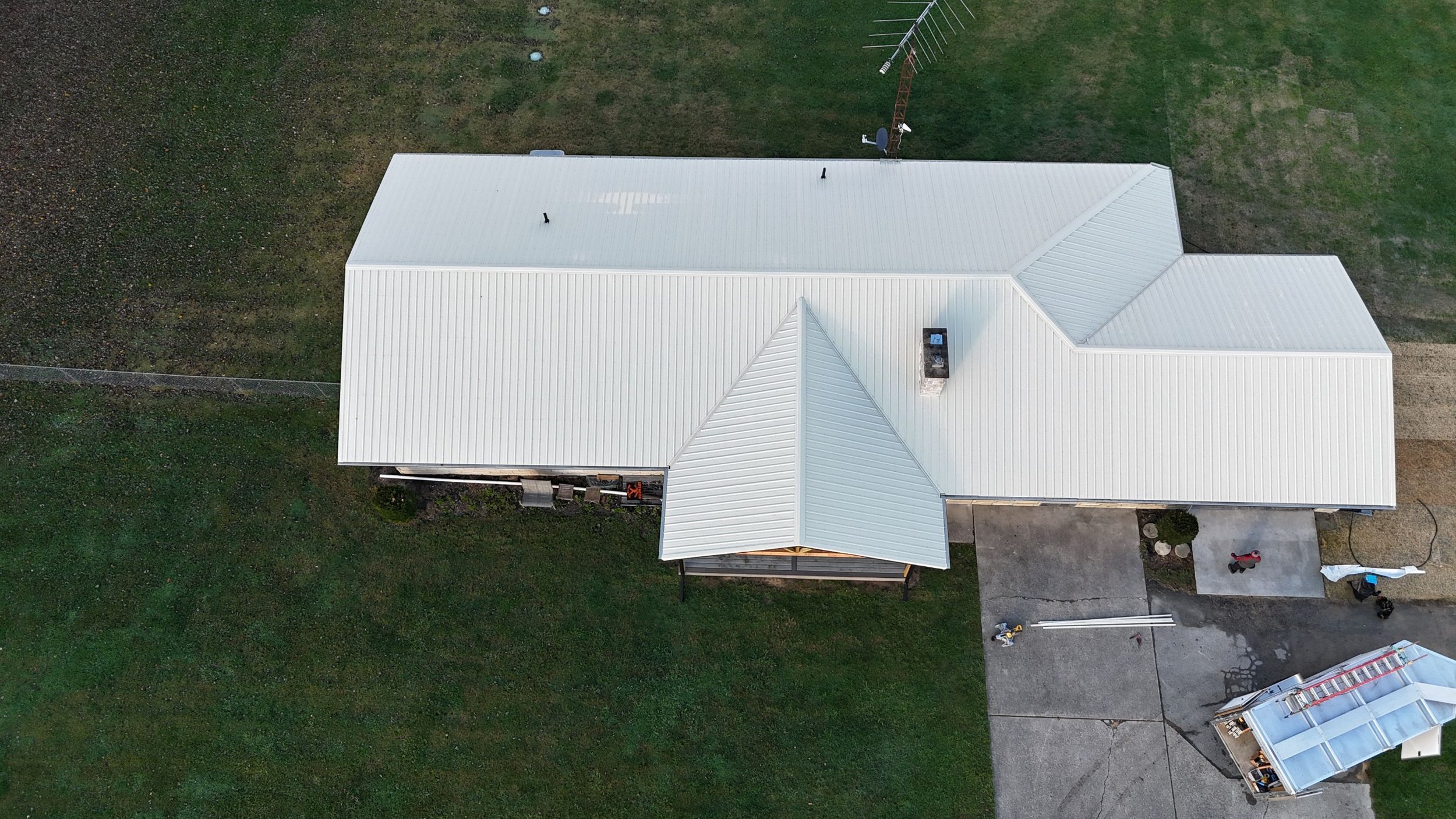 White standing seam metal roof installation completed by Red Roofing