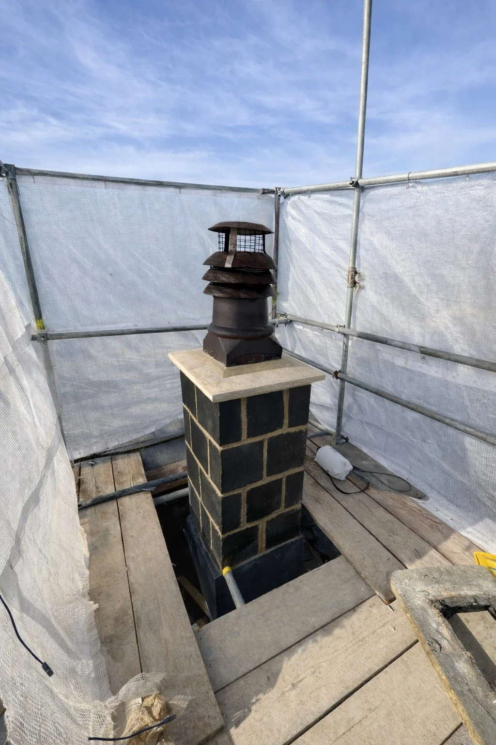 Restored chimney with string course plinth