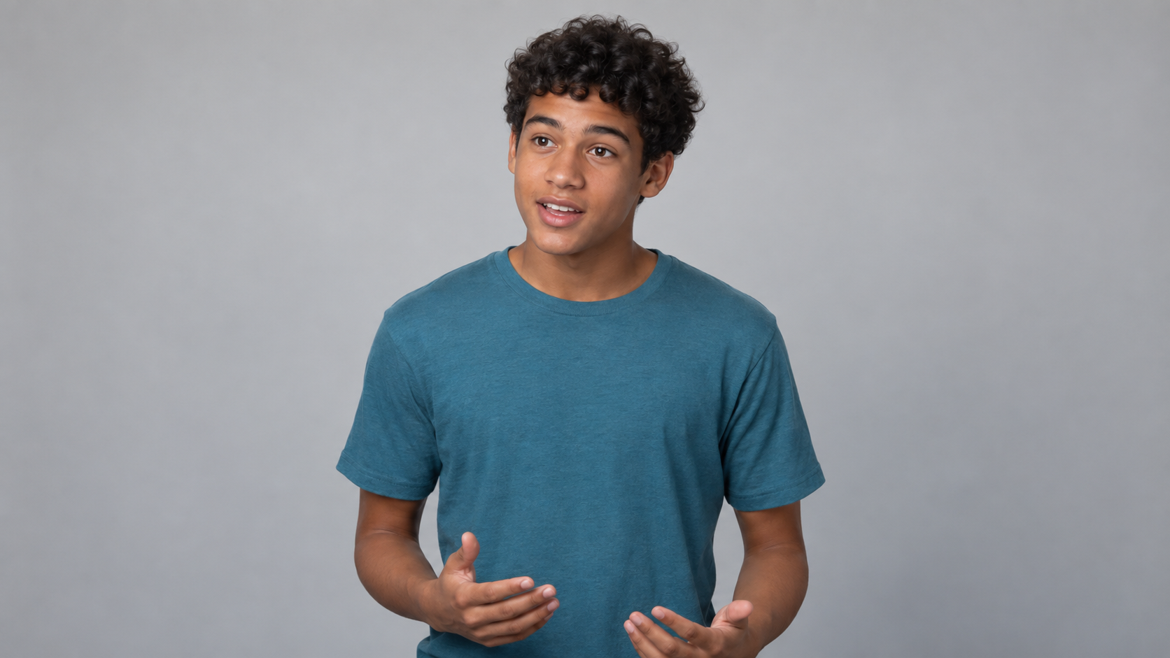 Boy demonstrating proper chest-up framing for a musical theater audition self-tape, with his face clearly visible and centered in the camera frame.