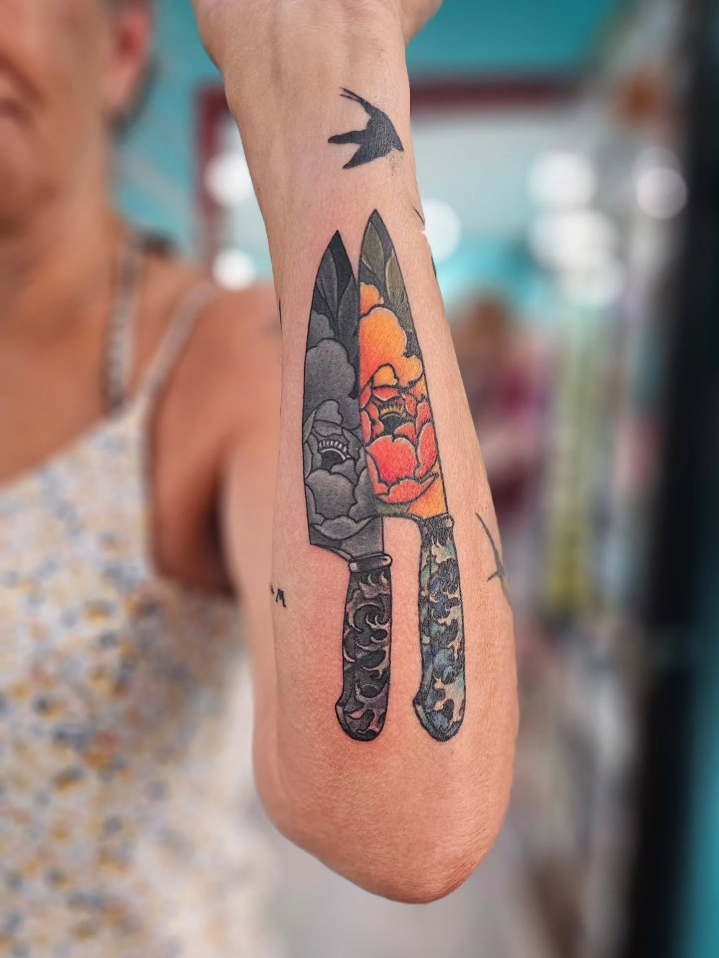 This client came to us wanting more from her pre-existing #knifetattoo. The original black shadow didn&rsquo;t feel quite right to her anymore, so Rob transformed it into a black and gray counterpart that complements the colorful original perfectly ?