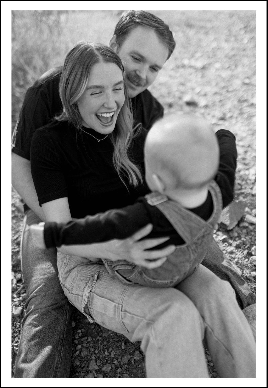Documentary style family session - a tender moment with enjoying new baby giggles.