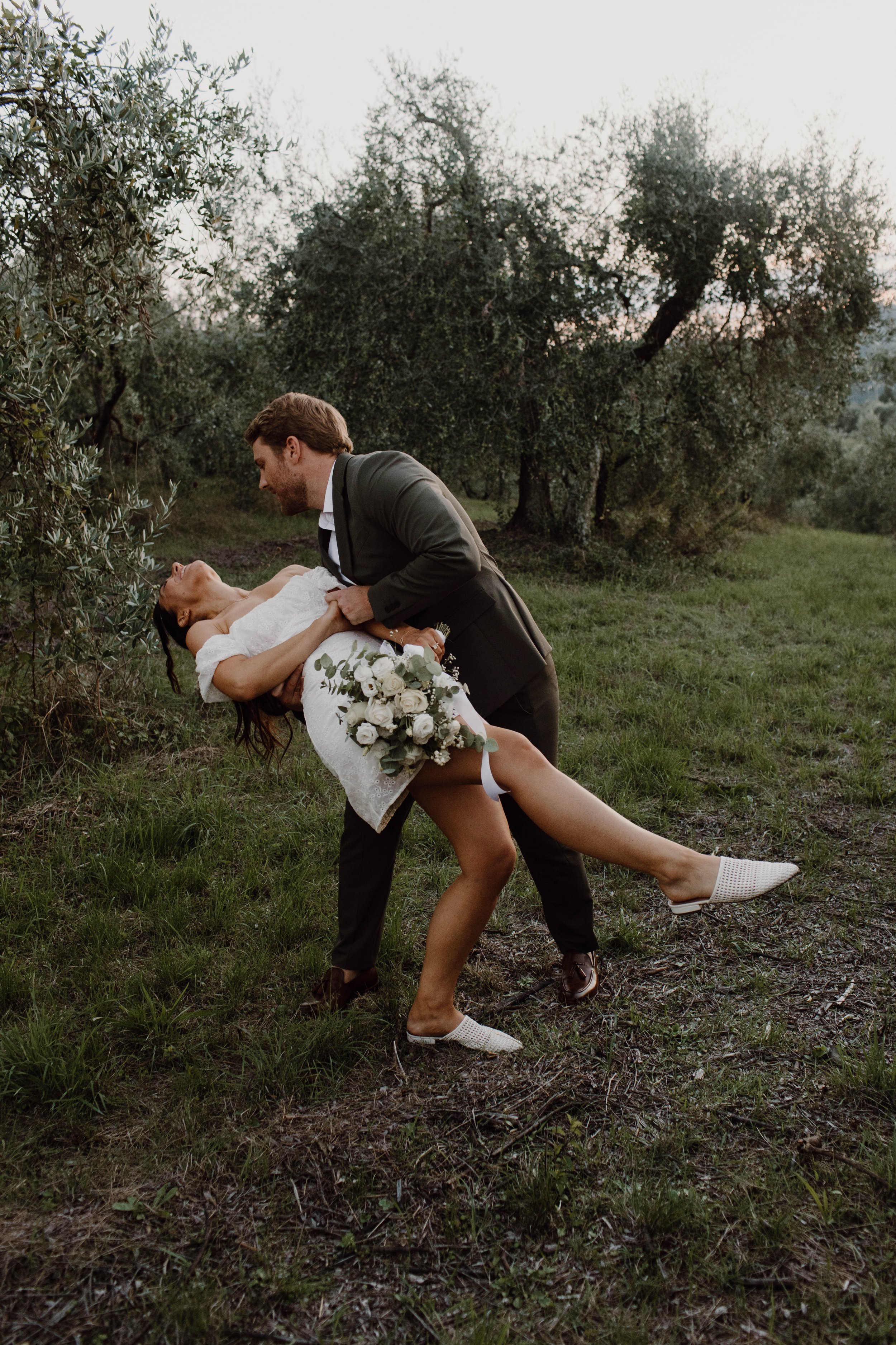 The moment the groom dips the bride after an intimate kiss - modern wedding photojournalism.
