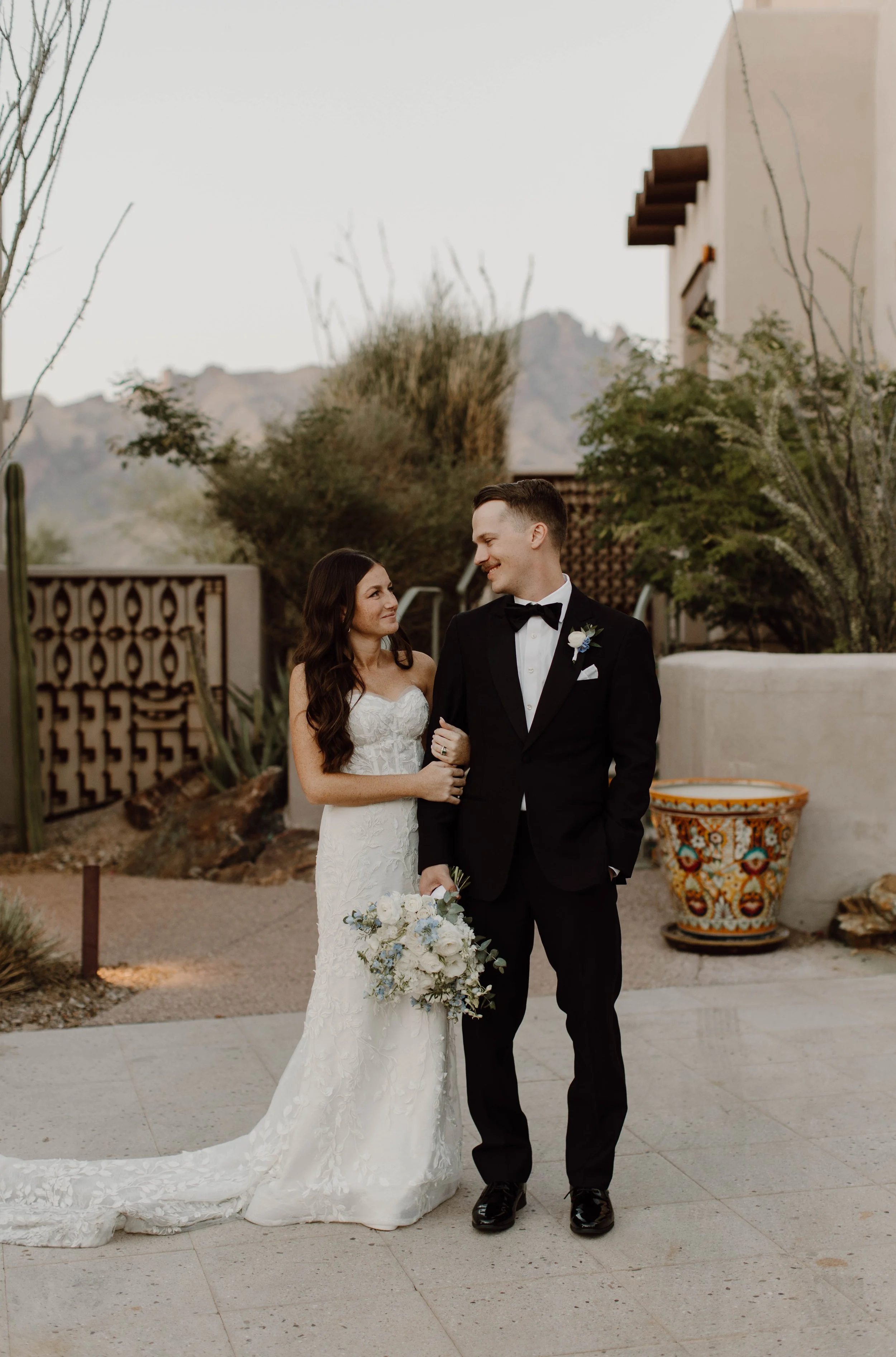 An editorial style wedding portrait of the couple with a desert backdrop, taken in Tucson, Arizona.