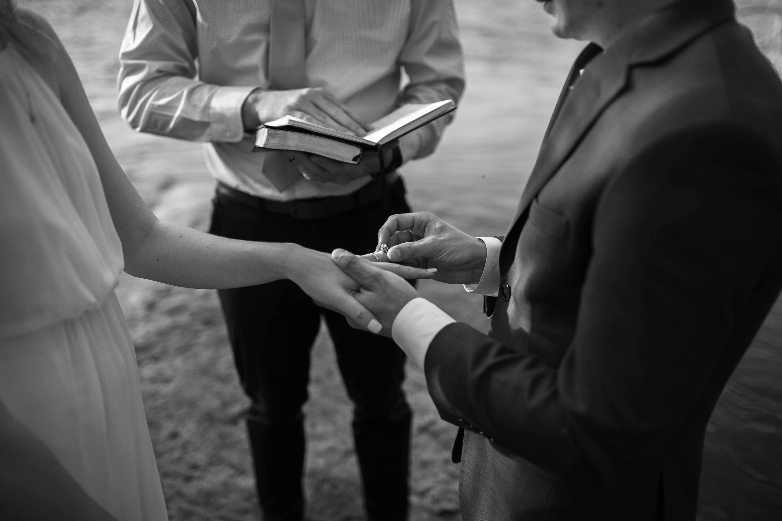 Bride and groom exchanging the rings - close up, intimate