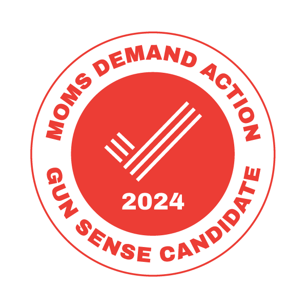 A circular logo with a black background, featuring red and black text. The outer ring reads "NOWS DEMAND ACTION GUN SENSE CANDIDATE" in red. The inner circle has a black check mark with three parallel lines to its right, and the year "2024" below.