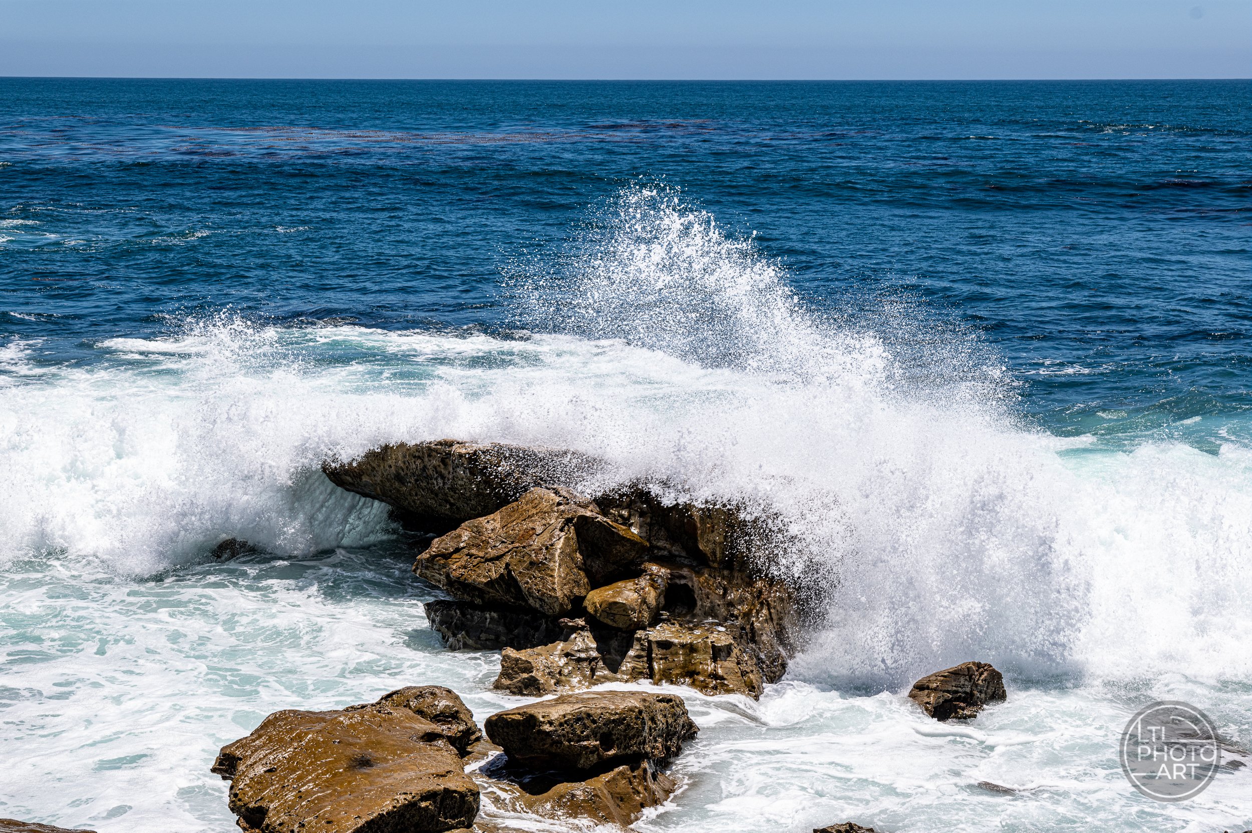 A breaking wave brings energy and drama to the Monument Point composition, showing how timing can transform a coastal photograph even when the camera settings remain the same.