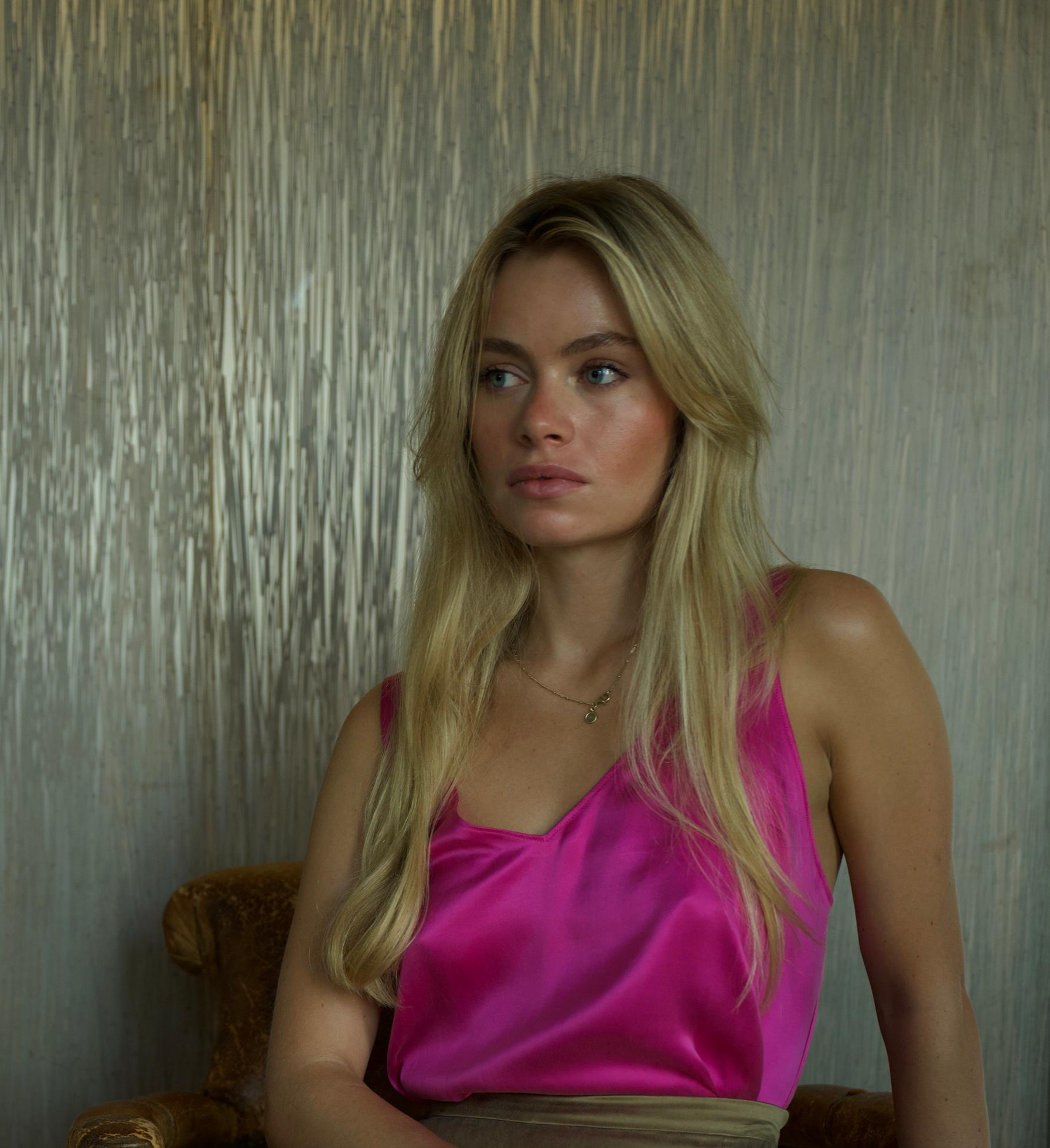 Woman wearing fuchsia silk top
