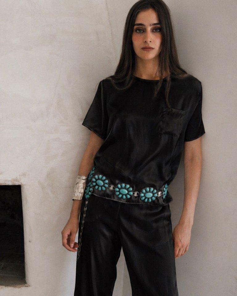 Woman wearing black silk T-shirt with matching trousers