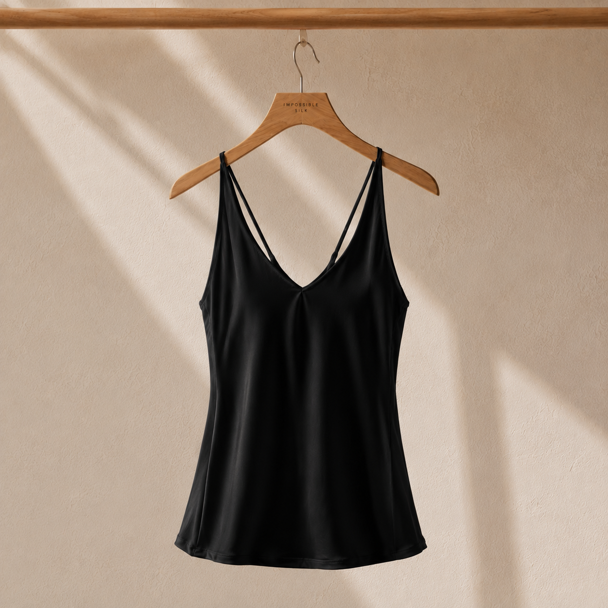 Black silk camisole top on hanger