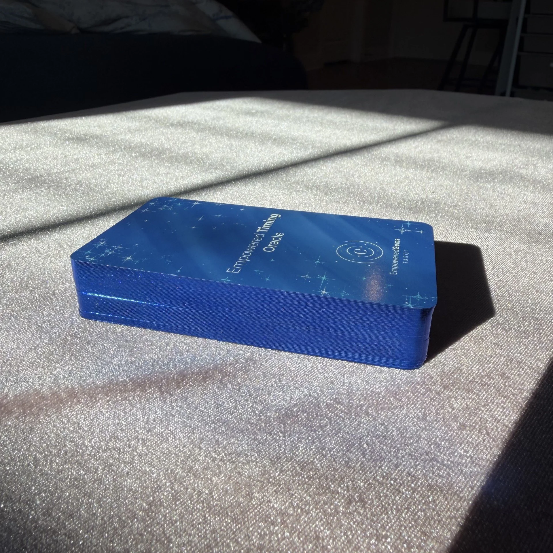 Empowered Timing Oracle blue gilt edge card deck in sunlight