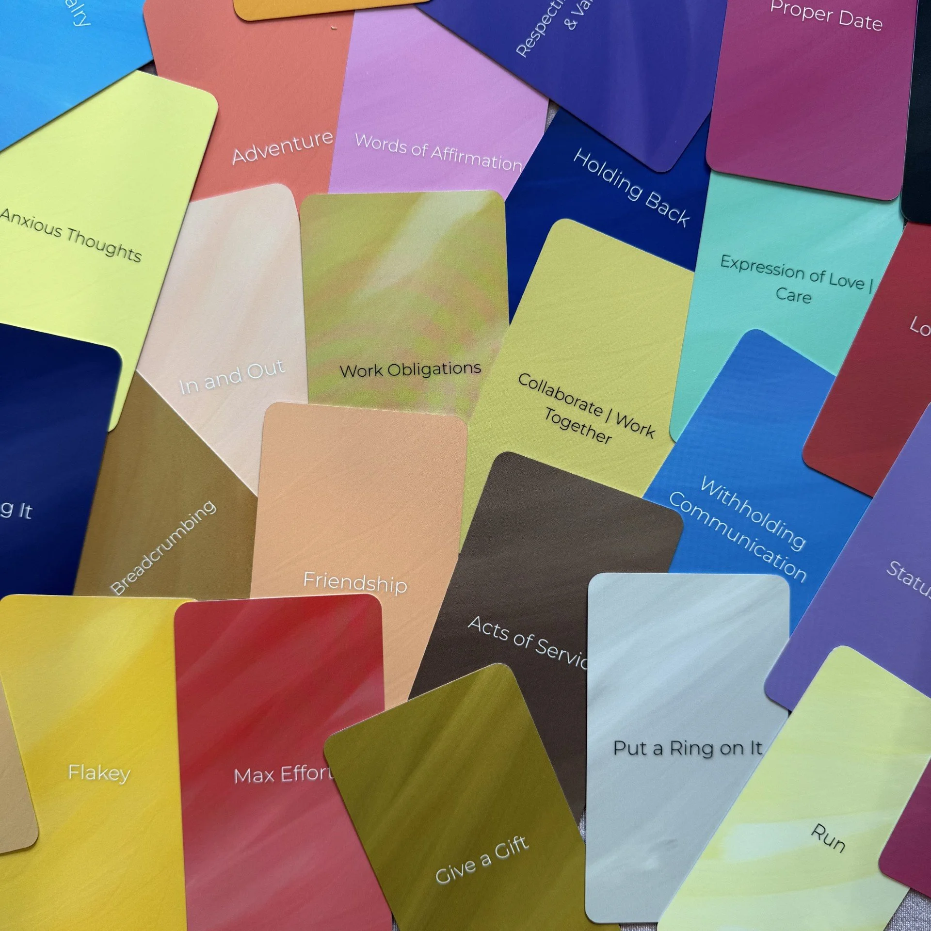 Empowered Action Love Oracle scattered card faces showing full color range. 