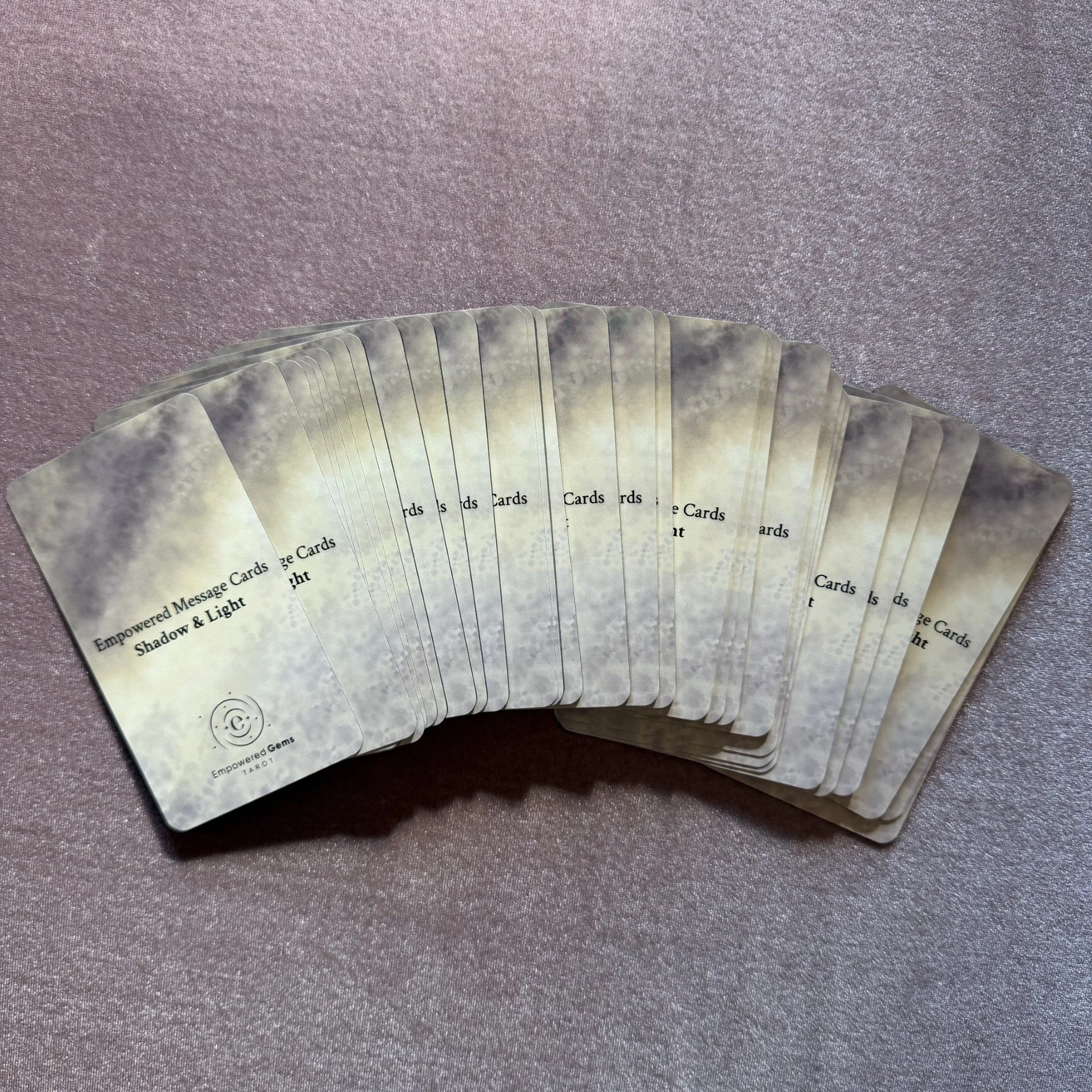 Empowered Message Cards Shadow and Light 90 card fan spread on mauve background
