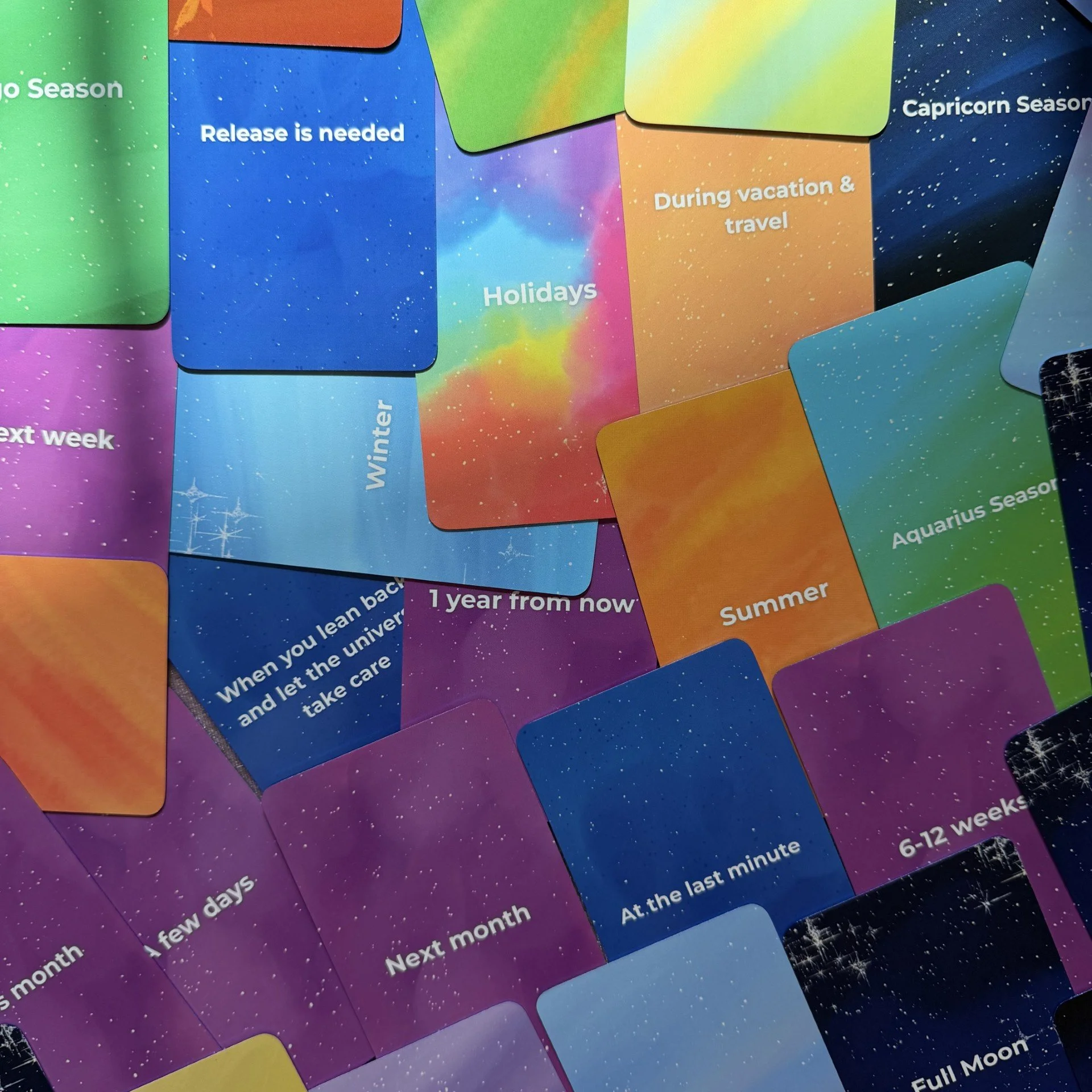 Empowered Timing Oracle scattered card faces showing full color range