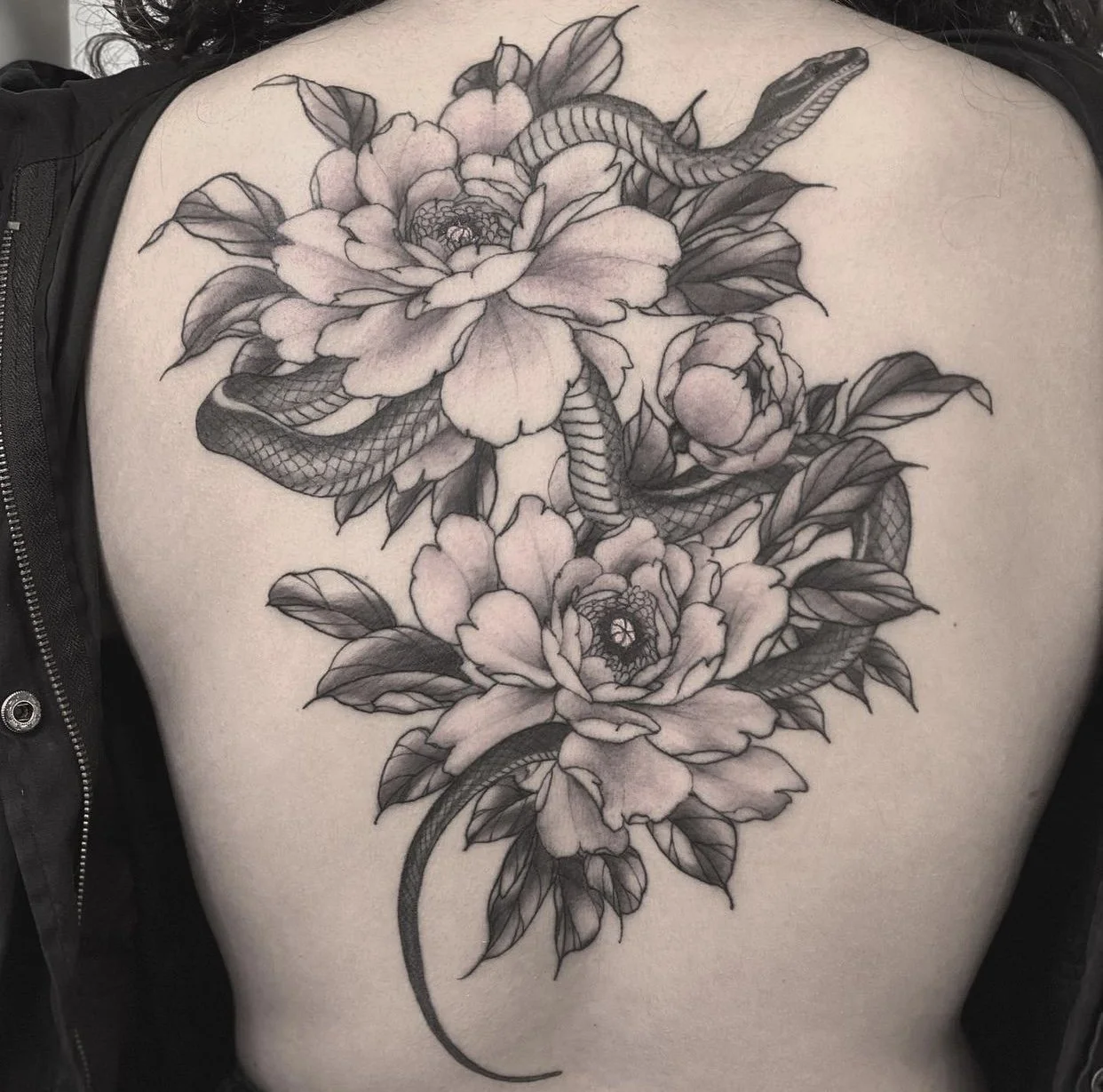Best bay area fine line snake and peony tattoo. Back piece.