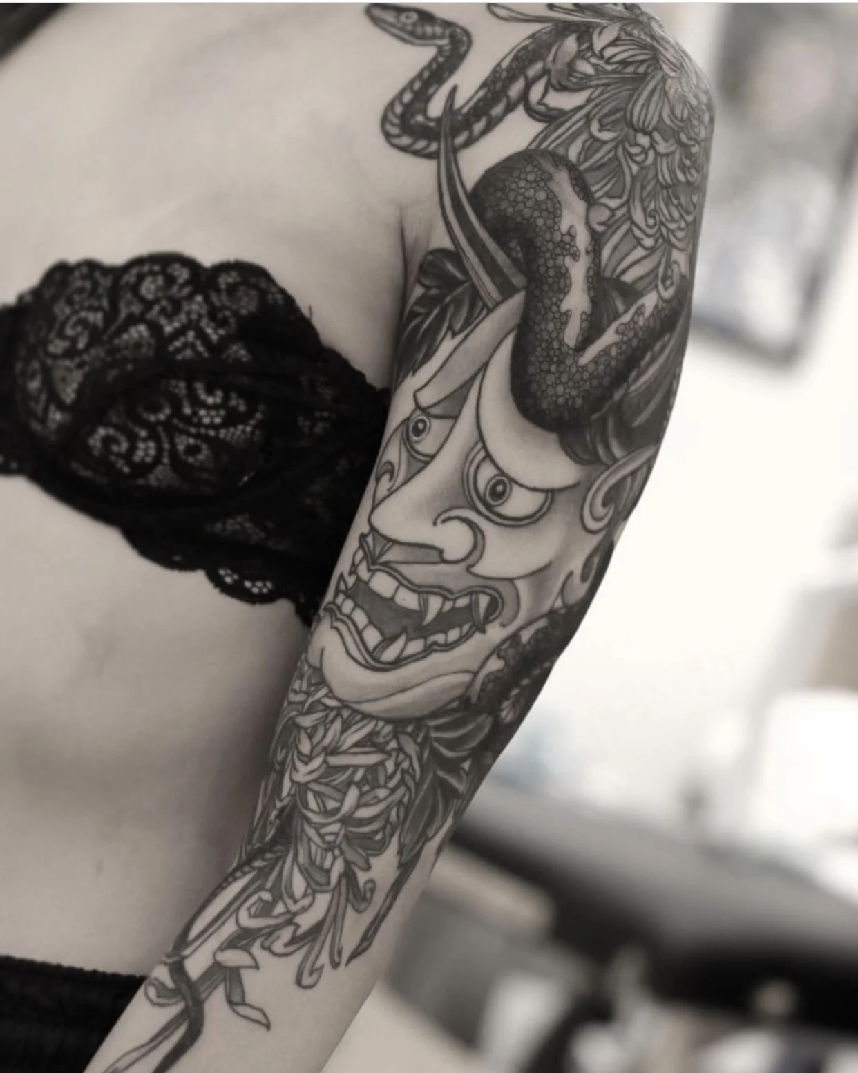 snake and flower tattoo on arm. With a hanya mask and chrysanthemum