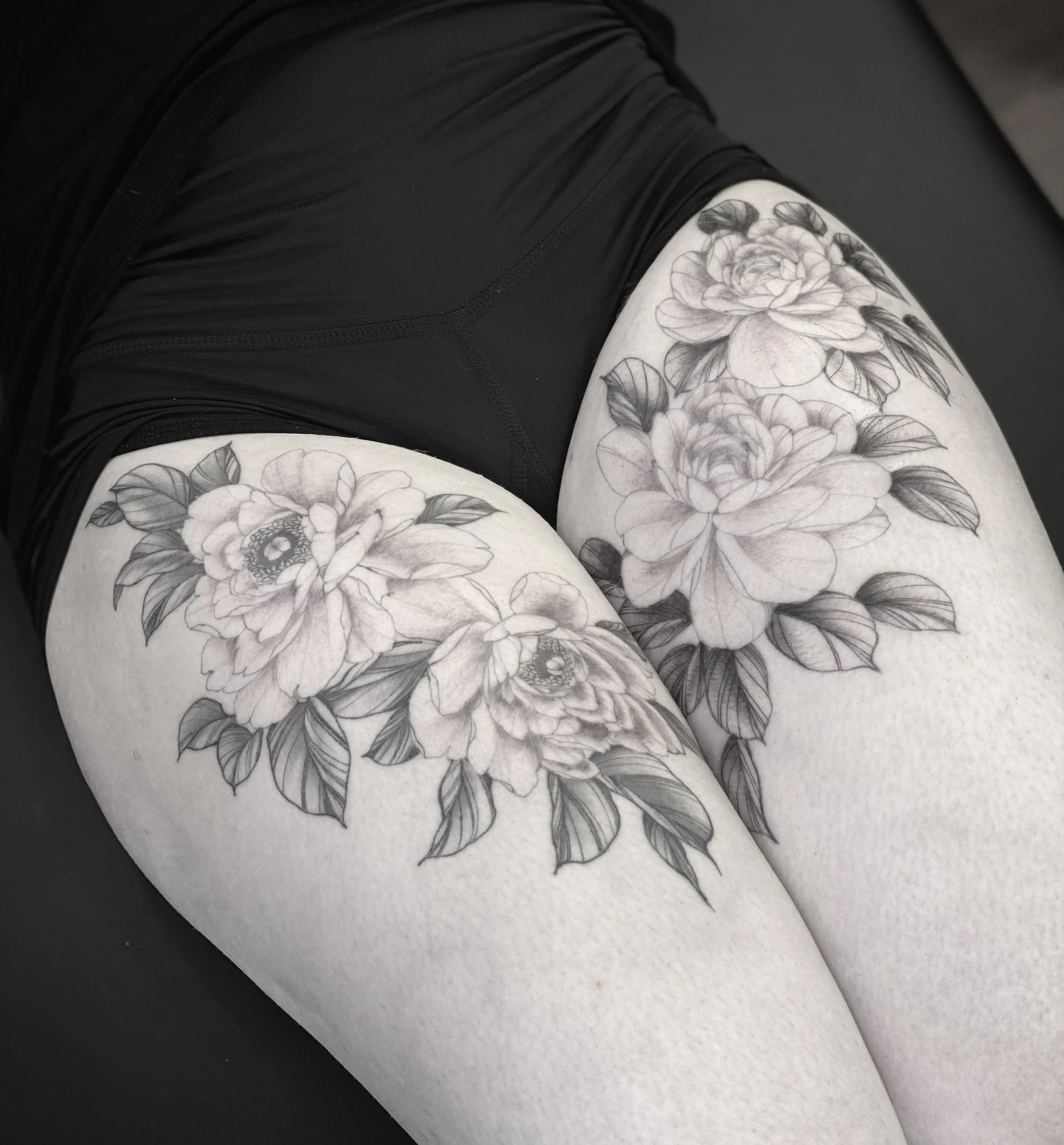 Best bay area fine line peony flowers tattoo on the thigh.