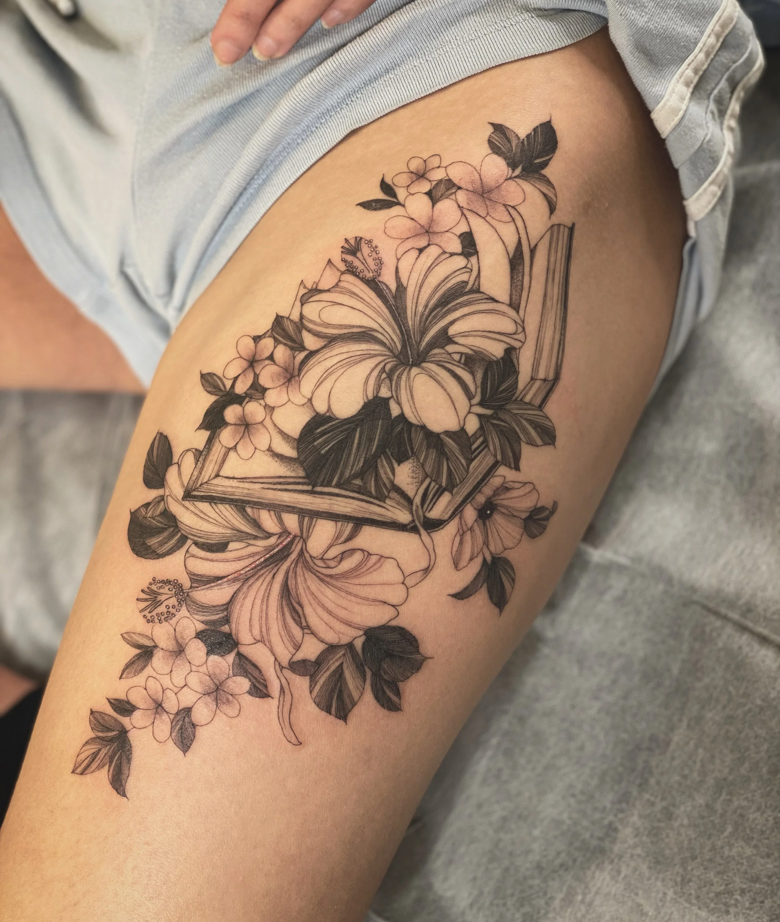 Best bay area fine line floral thigh tattoo