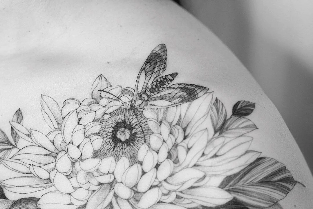 Black and white line drawing of a flower bouquet with a dragonfly on top.