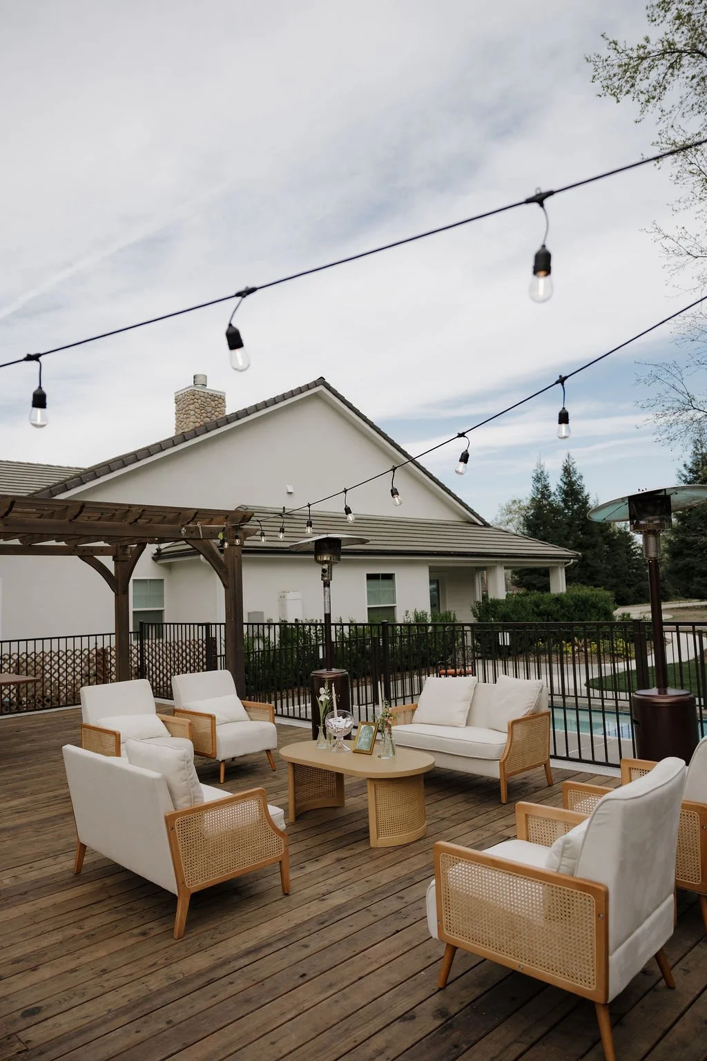 A newlywed couple sharing a romantic moment at their outdoor wedding ceremony, surrounded by floral arrangements and elegant decor.