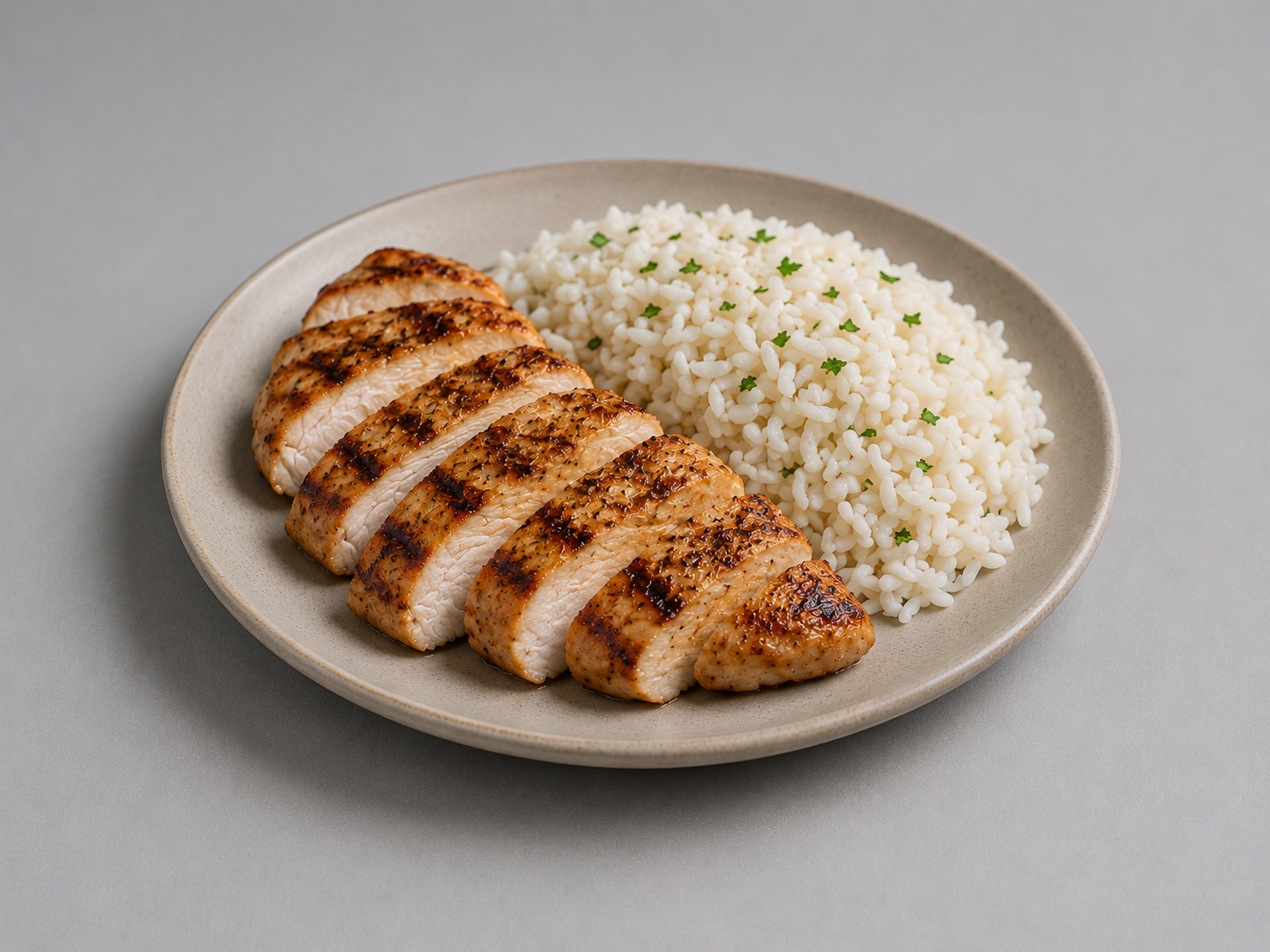 Rice and grilled chicken on a plate.