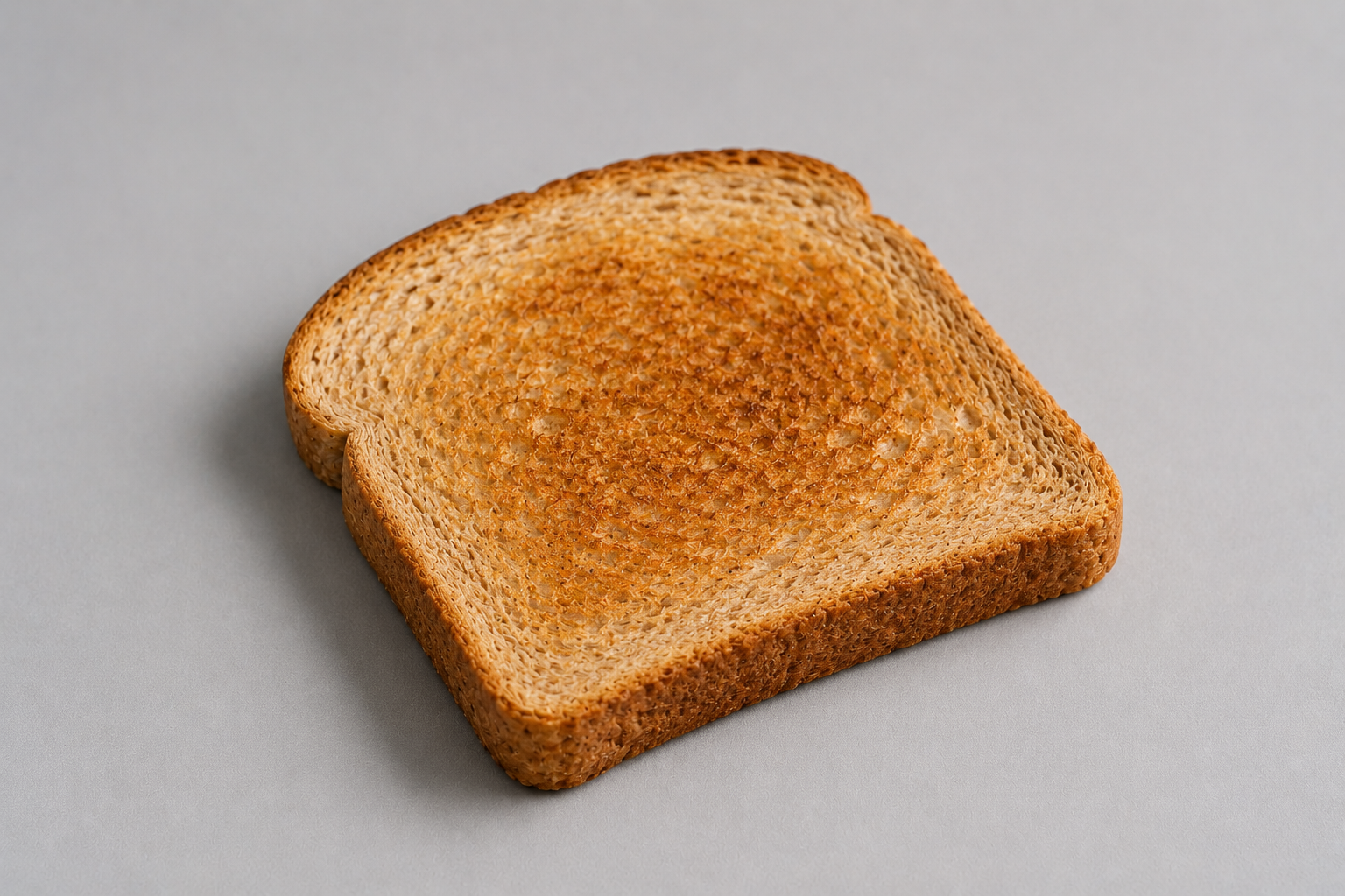 a plain piece of toast on the table.