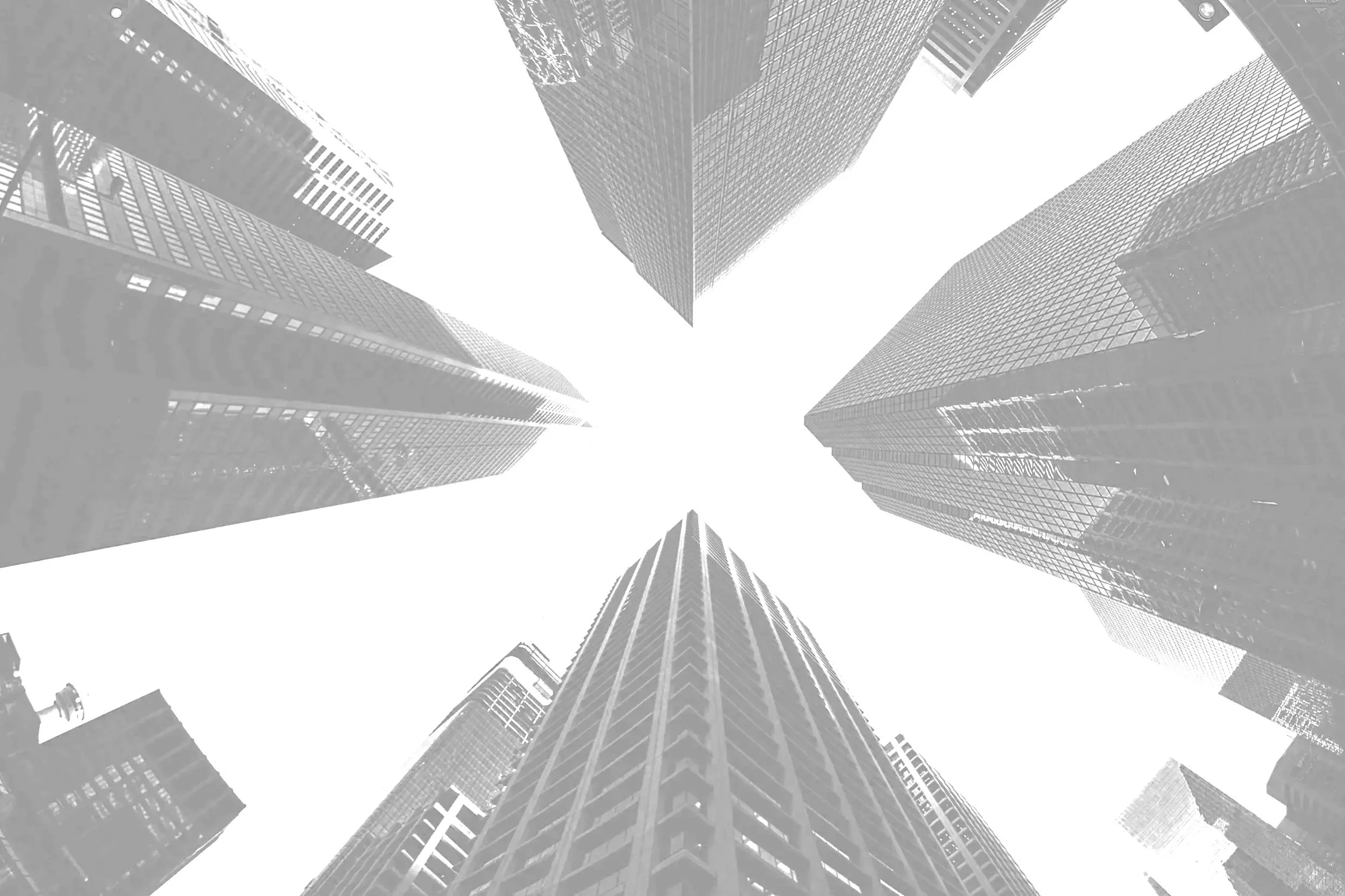 Looking up at tall skyscrapers in a city, black and white photo