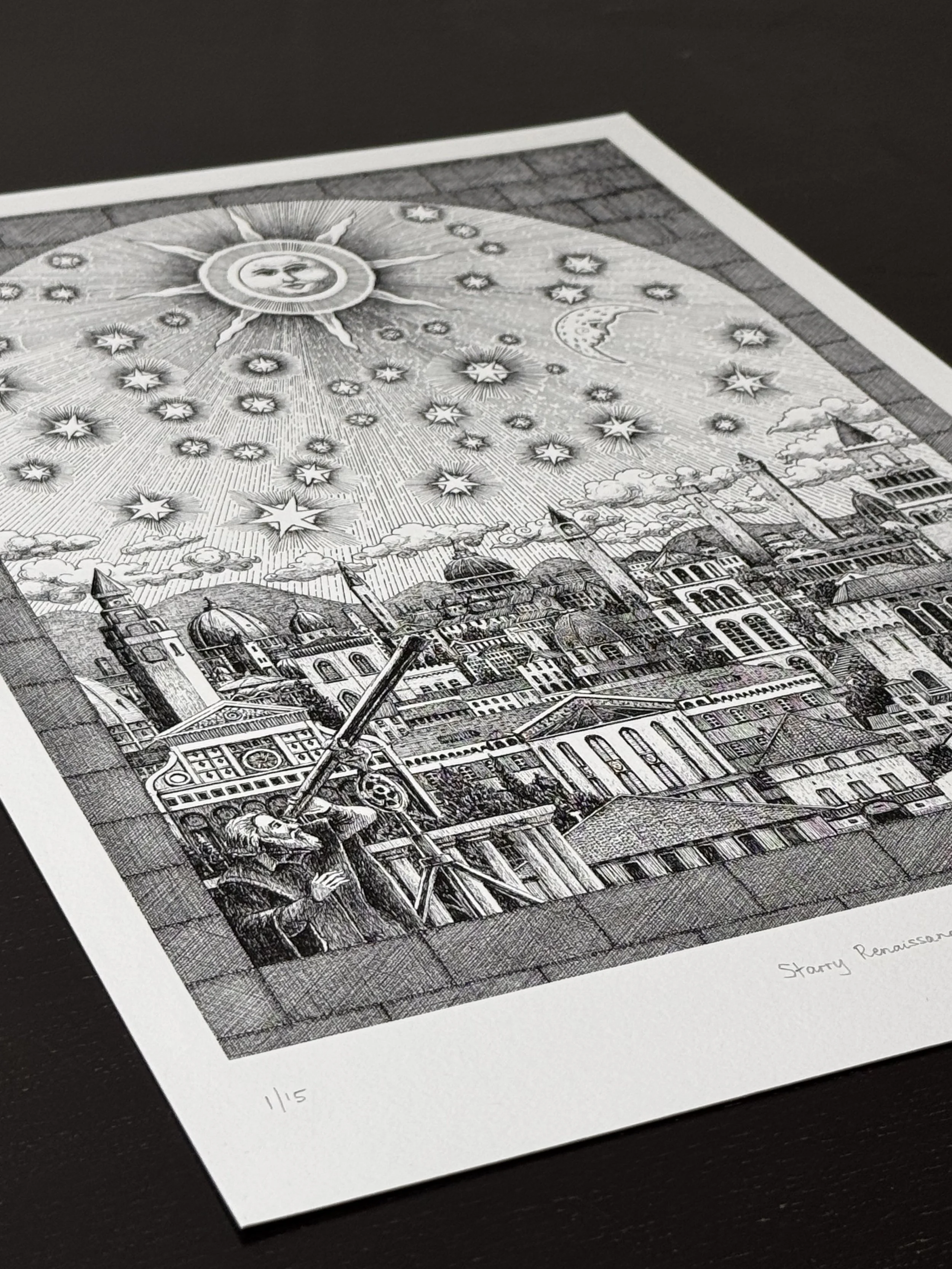 Angled view of the Starry Renaissance art print showing a Renaissance city beneath a celestial sky, printed in black and white pen and ink on fine art paper.