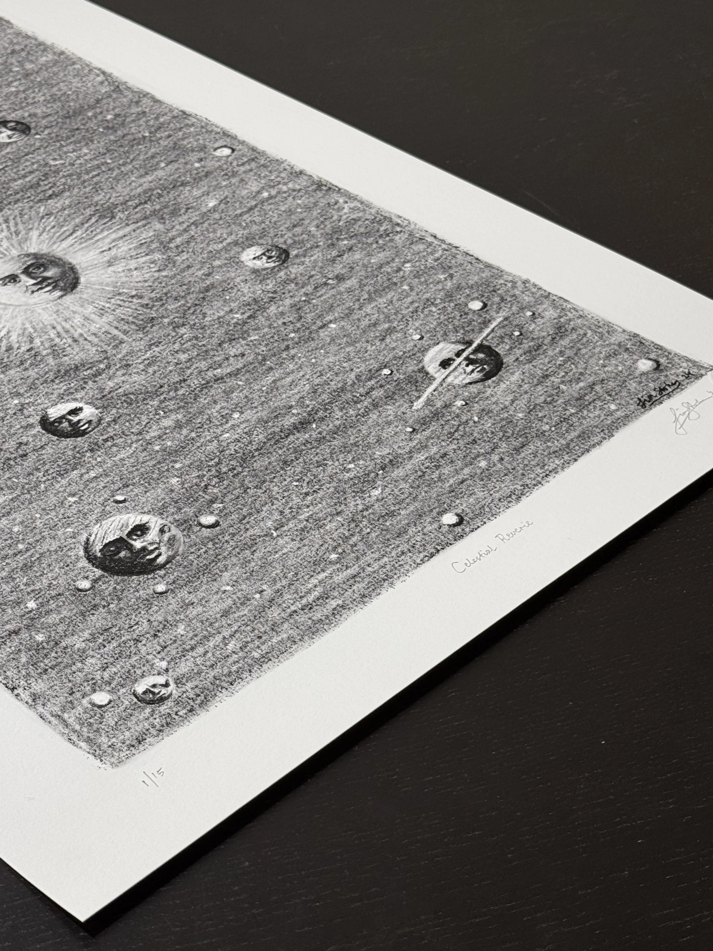 Angled view of the Celestial Reverie limited edition art print, showing detailed charcoal textures, celestial faces, and atmospheric space imagery on fine art paper.