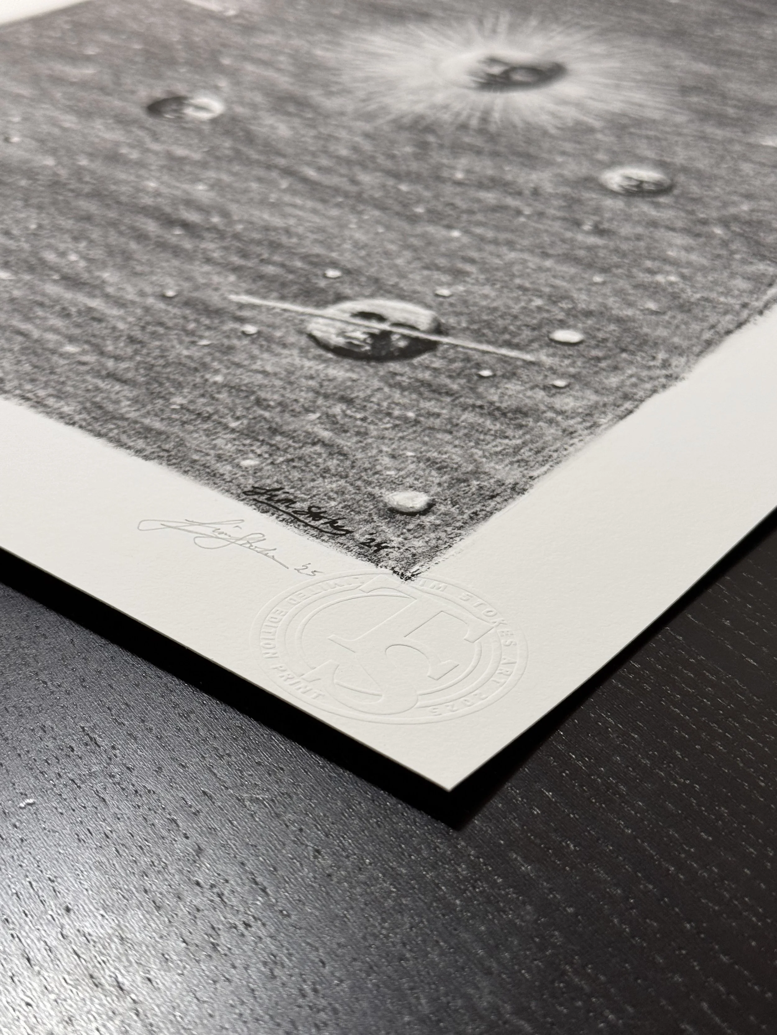 Detailed close up of the embossed limited edition seal and hand signature on the Celestial Reverie fine art print by Tim Stokes.