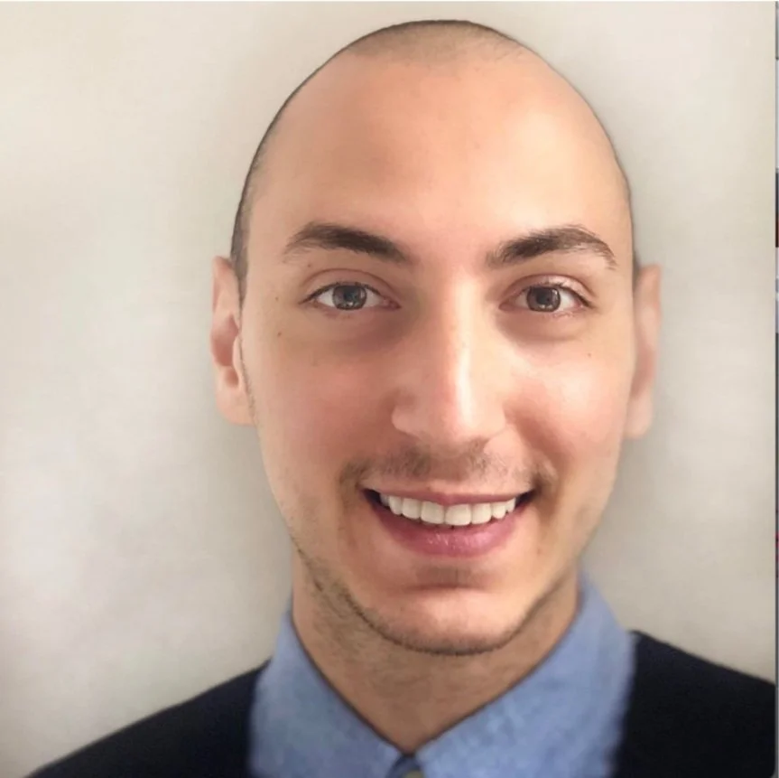 Man confidently looking at us and smiling