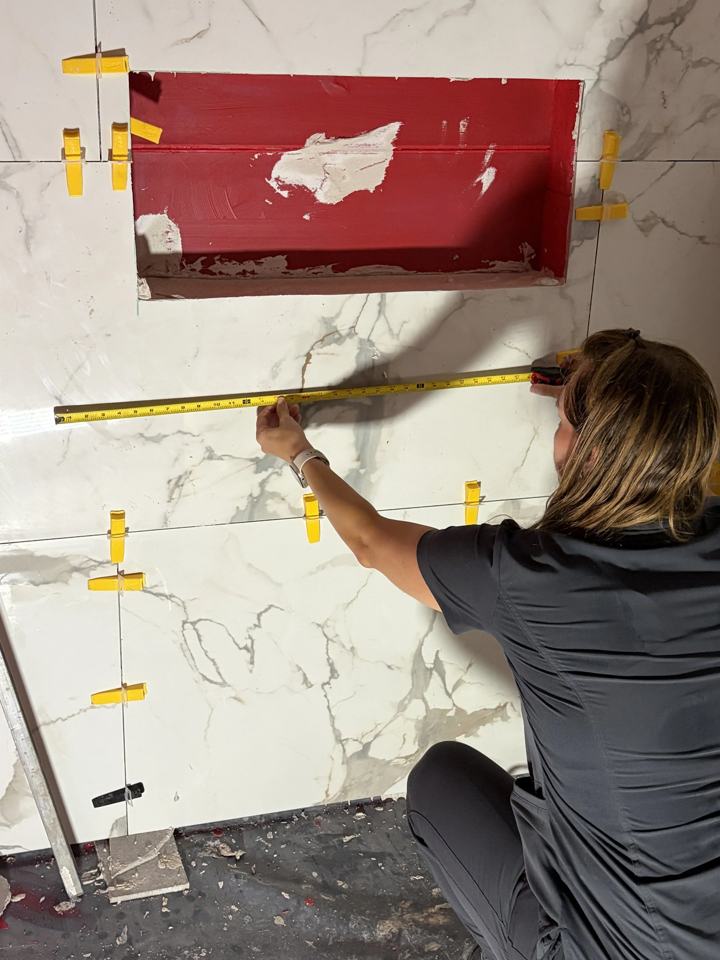 Doctor of Physical Therapy measuring a bathroom during an in-home mobility and remodeling consultation in Houston