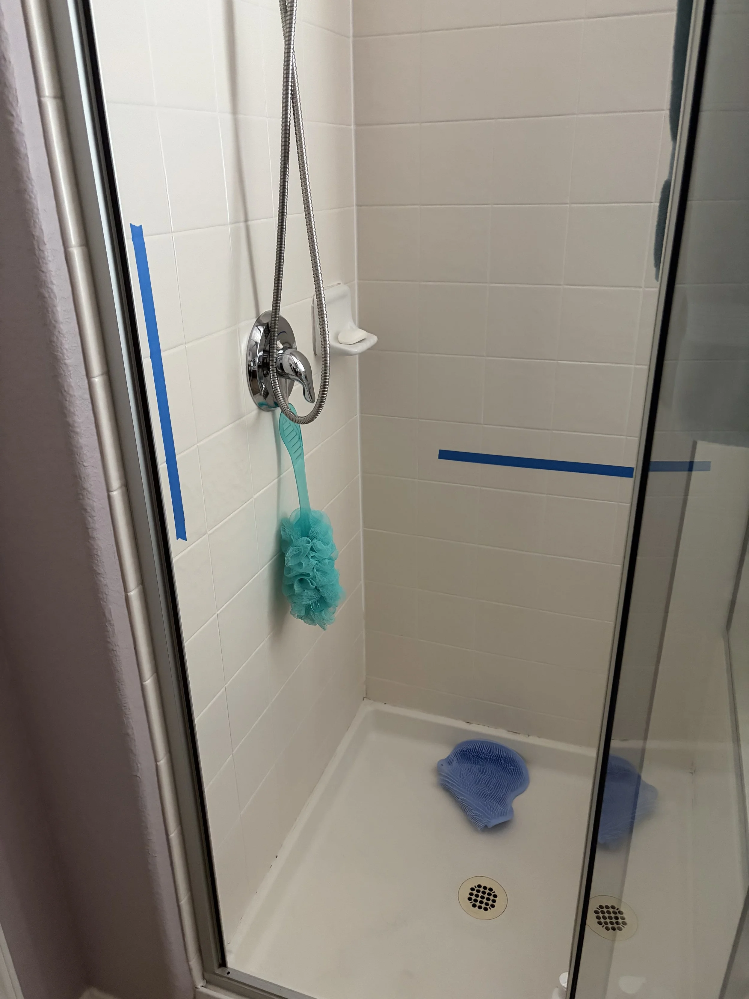 Grab bar placement marked in shower before installation in Houston home