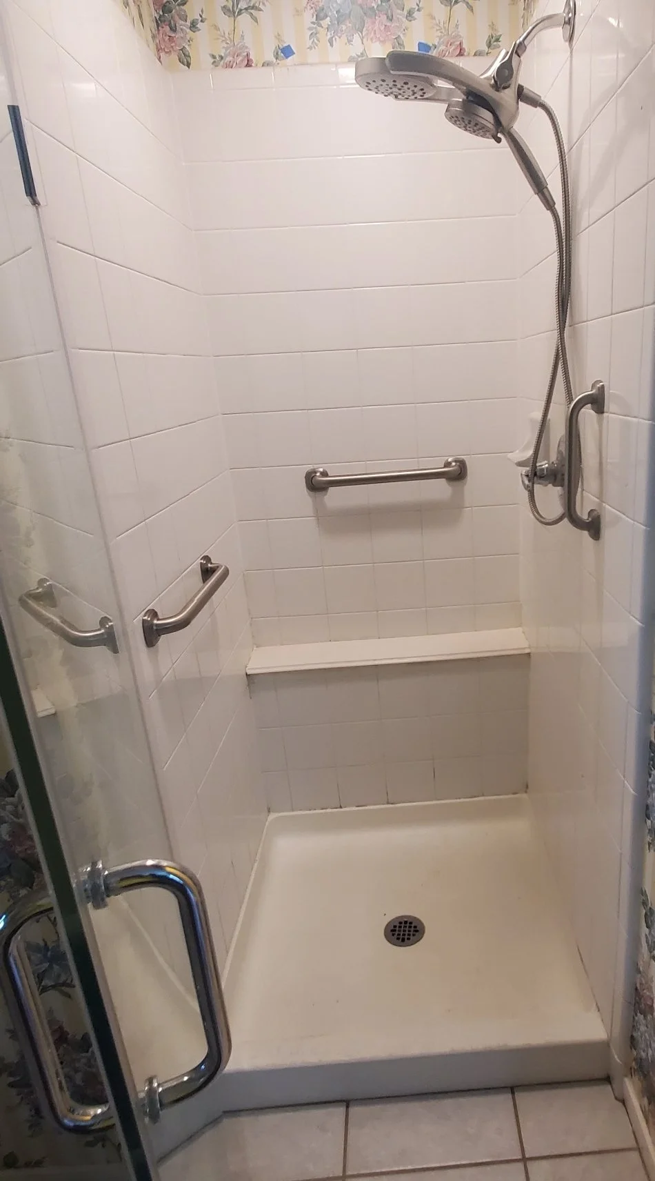 Accessible shower with grab bars and built-in bench for safer bathroom mobility and aging in place