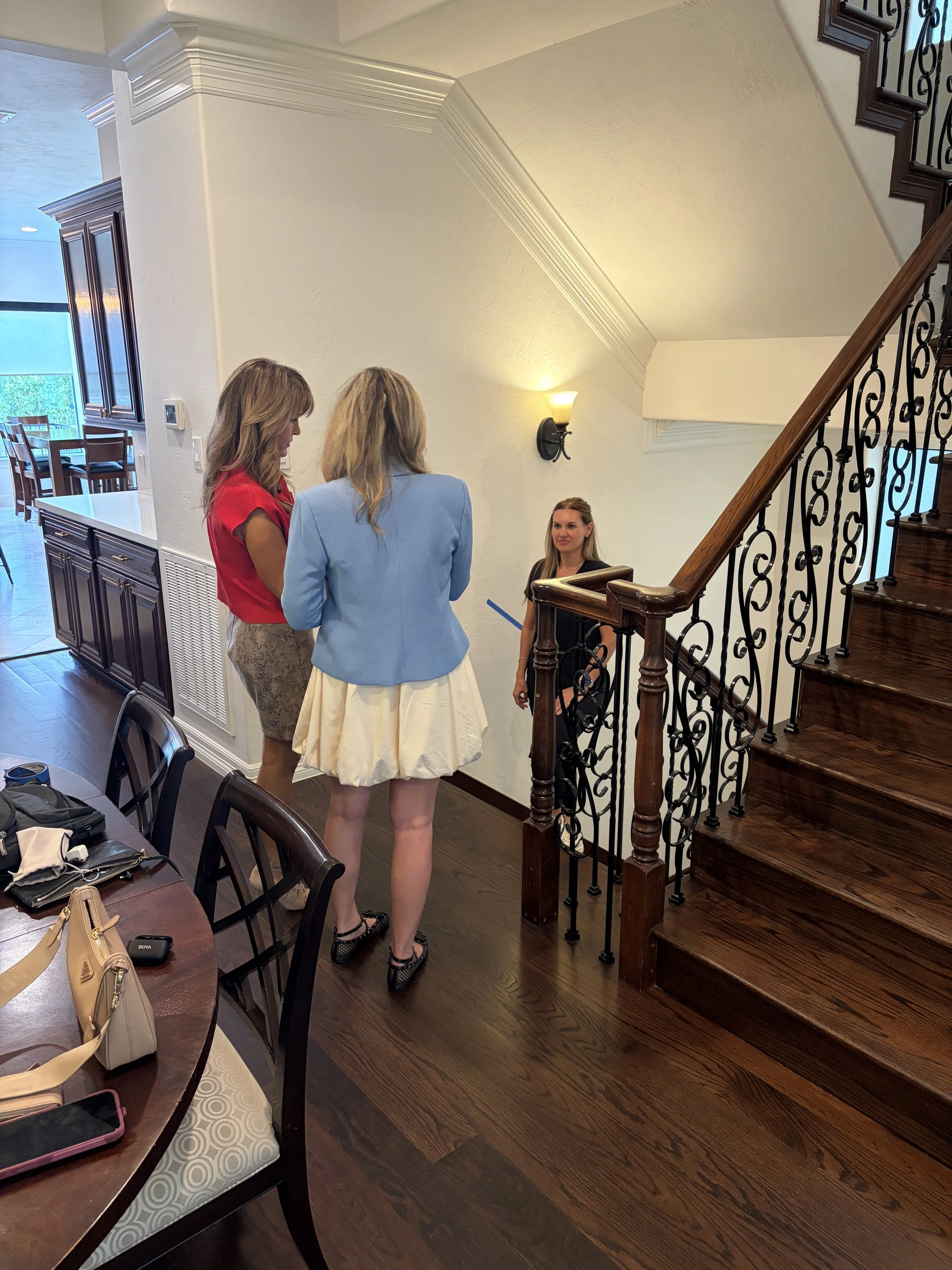 Doctor of Physical Therapy reviewing stairs and mobility needs with a family during an in-home consultation