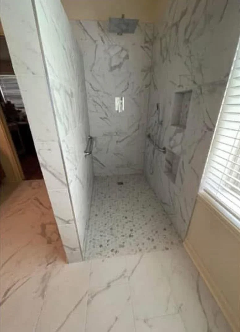Roll-in shower with grab bar and non-slip tile for wheelchair accessibility in Houston