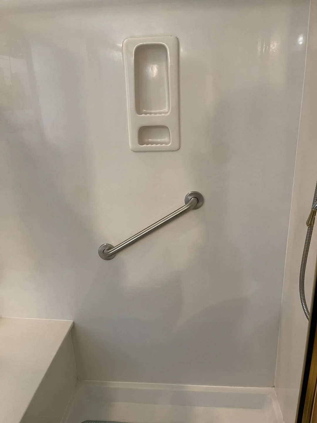 Grab bar installed at an angle in a Houston shower that may not support safe movement