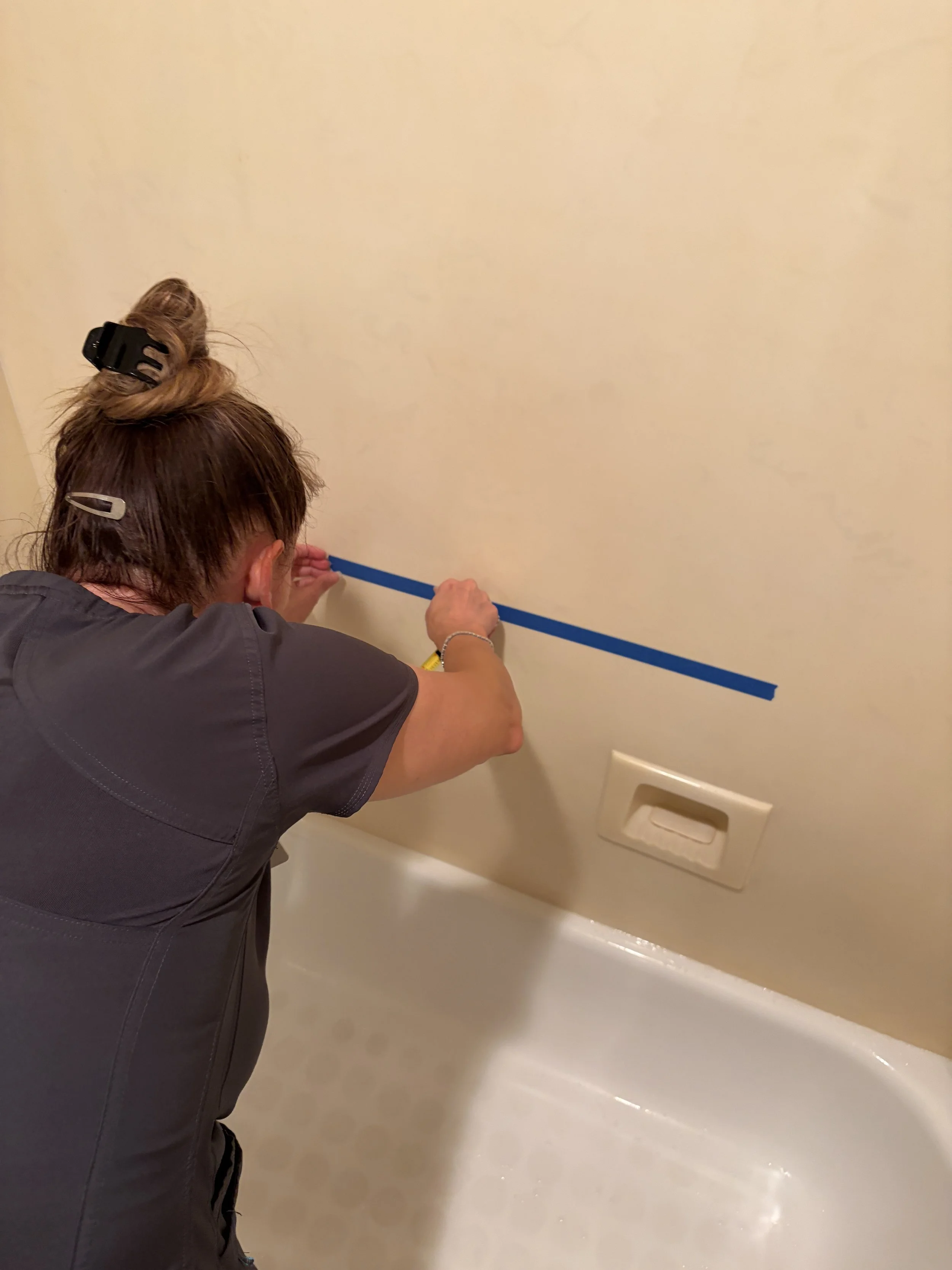 Doctor of Physical Therapy marking personalized grab bar placement during an in-home consultation in Houston