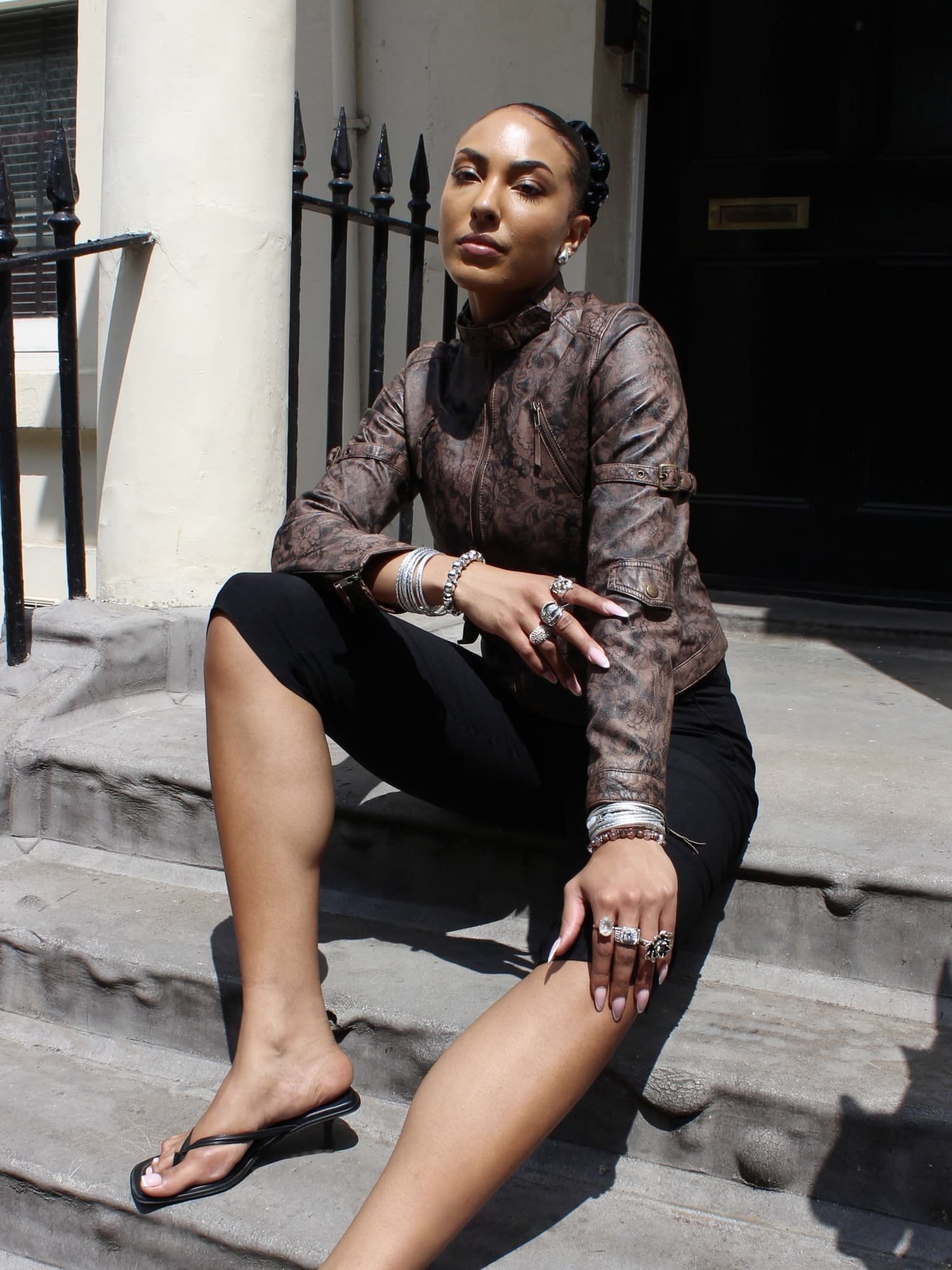 ANADELRIO-Velo-Jacket-V-OU-01-Leather-Print-BrownBlack-Model-Front-Sitting.jpg