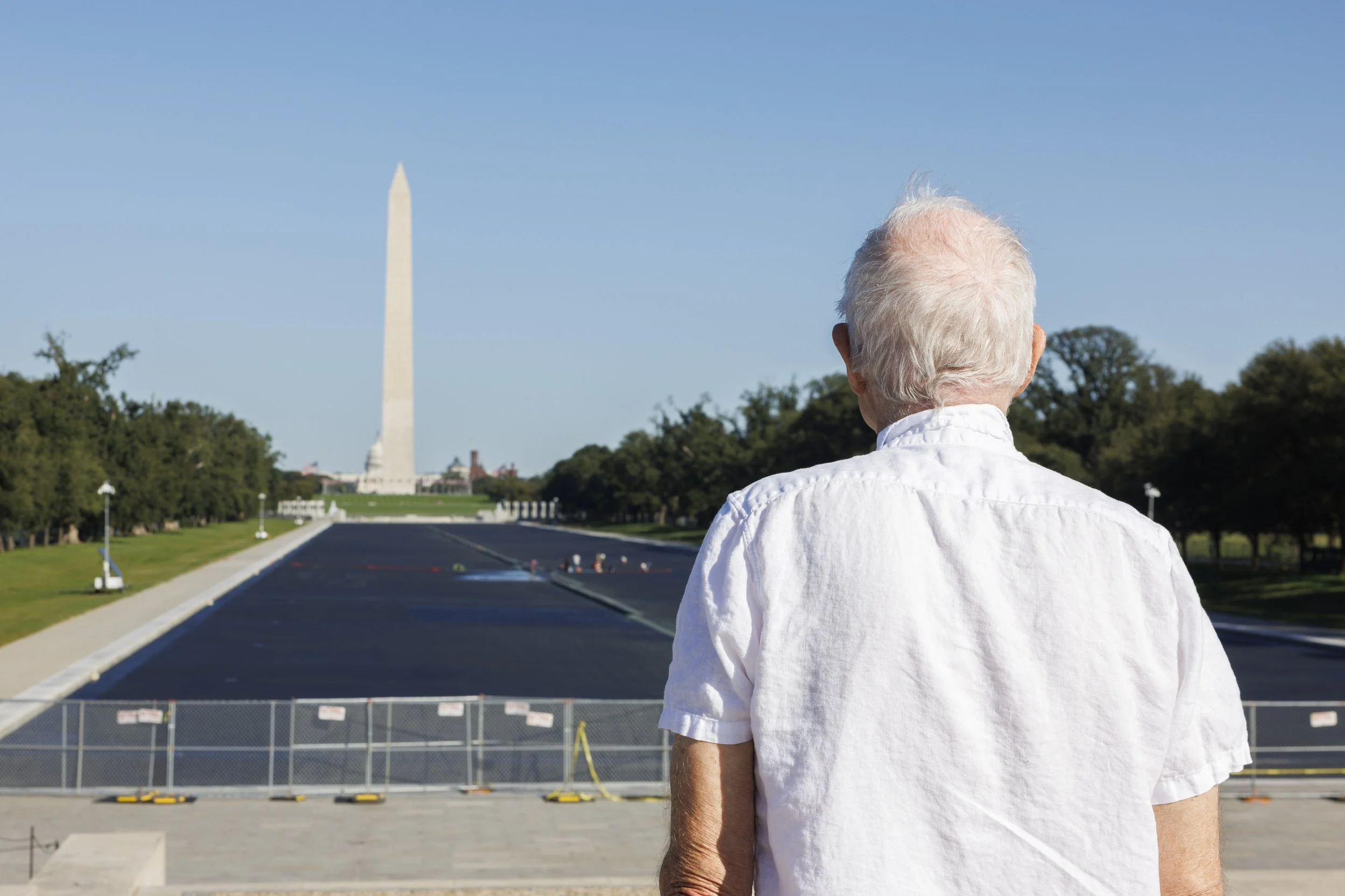 WASHINGTON — Workers continue repairs at the Lincoln Memorial Reflecting Pool on Oct. 7, 2026, with fencing surrounding the pool ahead of its expected reopening later in the week. (Liz Helgesen)