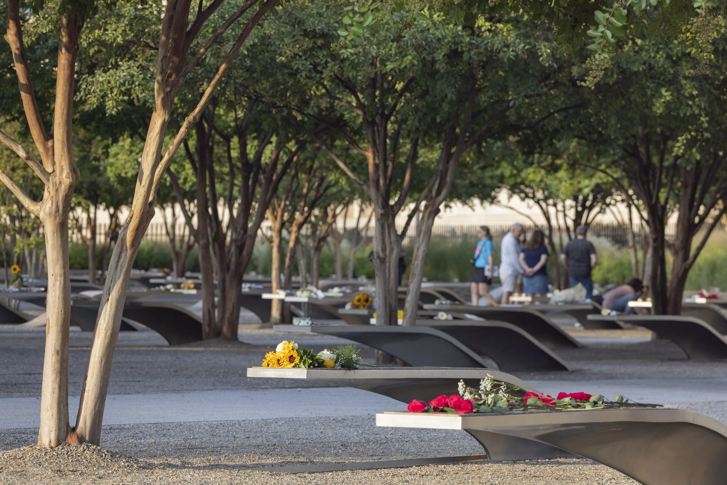 ARLINGTON, Va. — Visitors gather at the Pentagon Memorial on Sept. 11, 2026, the 25th anniversary of the 9/11 attacks. (Liz Helgesen)