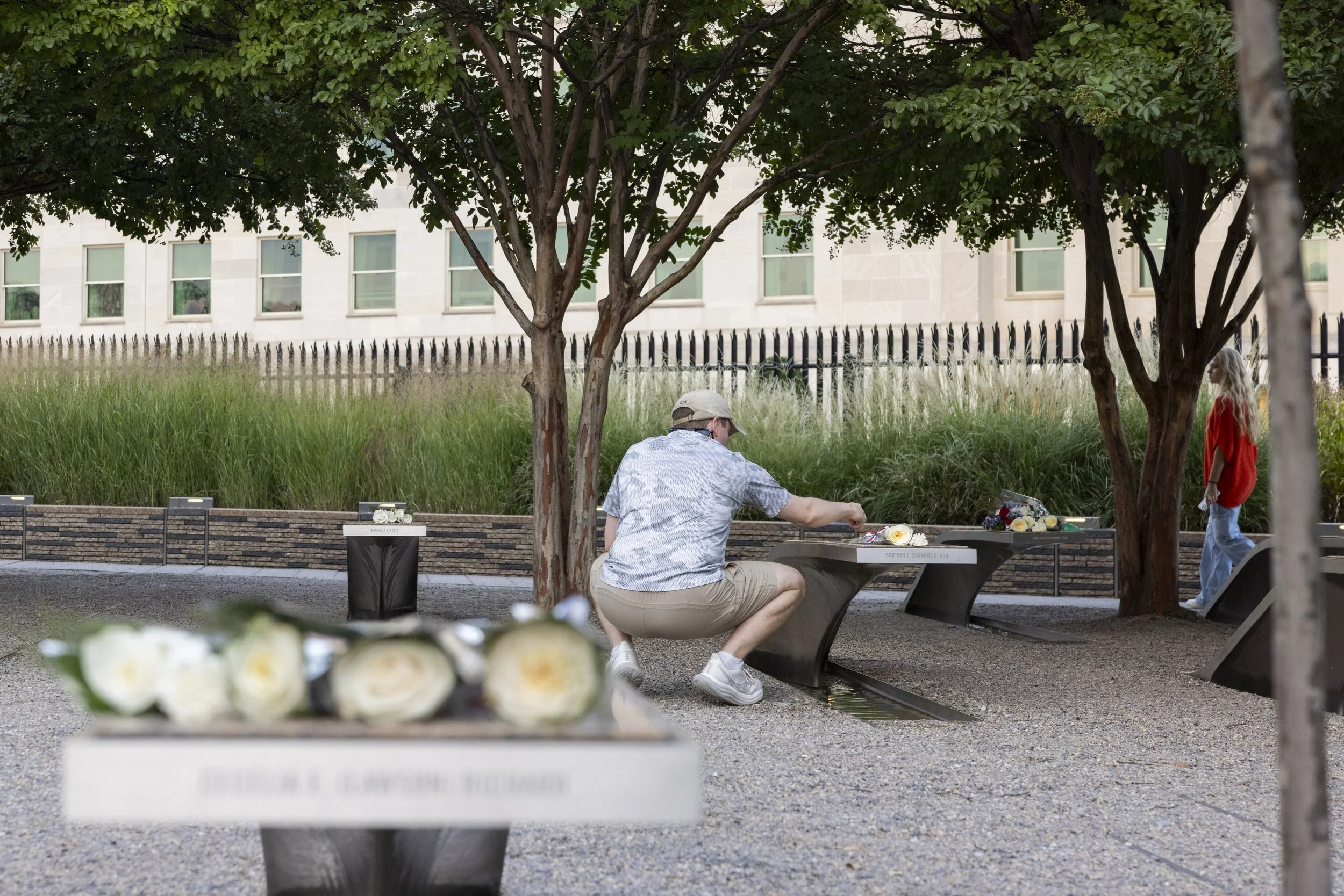 ARLINGTON, Va. — Visitors gather at the Pentagon Memorial on Sept. 11, 2026, the 25th anniversary of the 9/11 attacks. (Liz Helgesen)