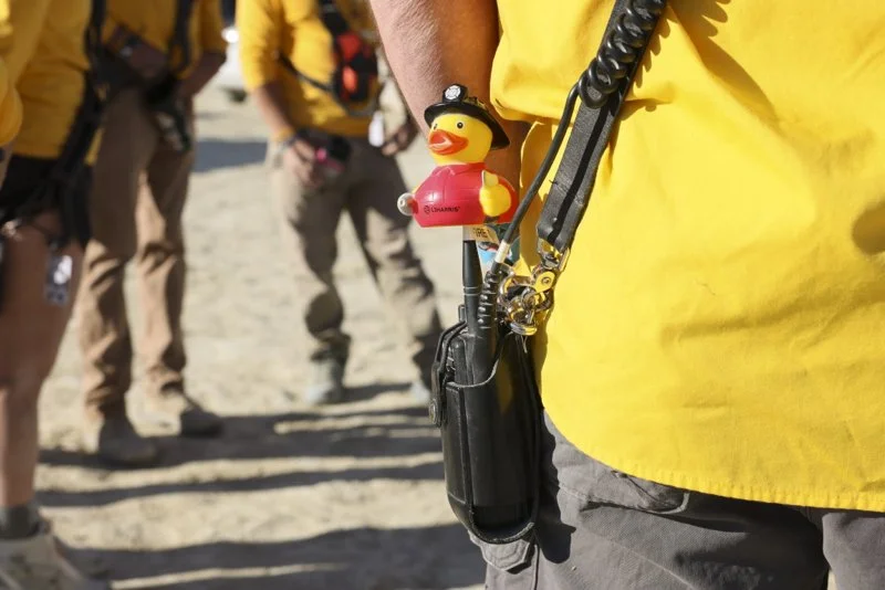 BLACK ROCK CITY, Nev. — A fire crew gathers for a brief meeting during a shift change at Burning Man on Sept. 5, 2026. (Liz Helgesen/Photo)
