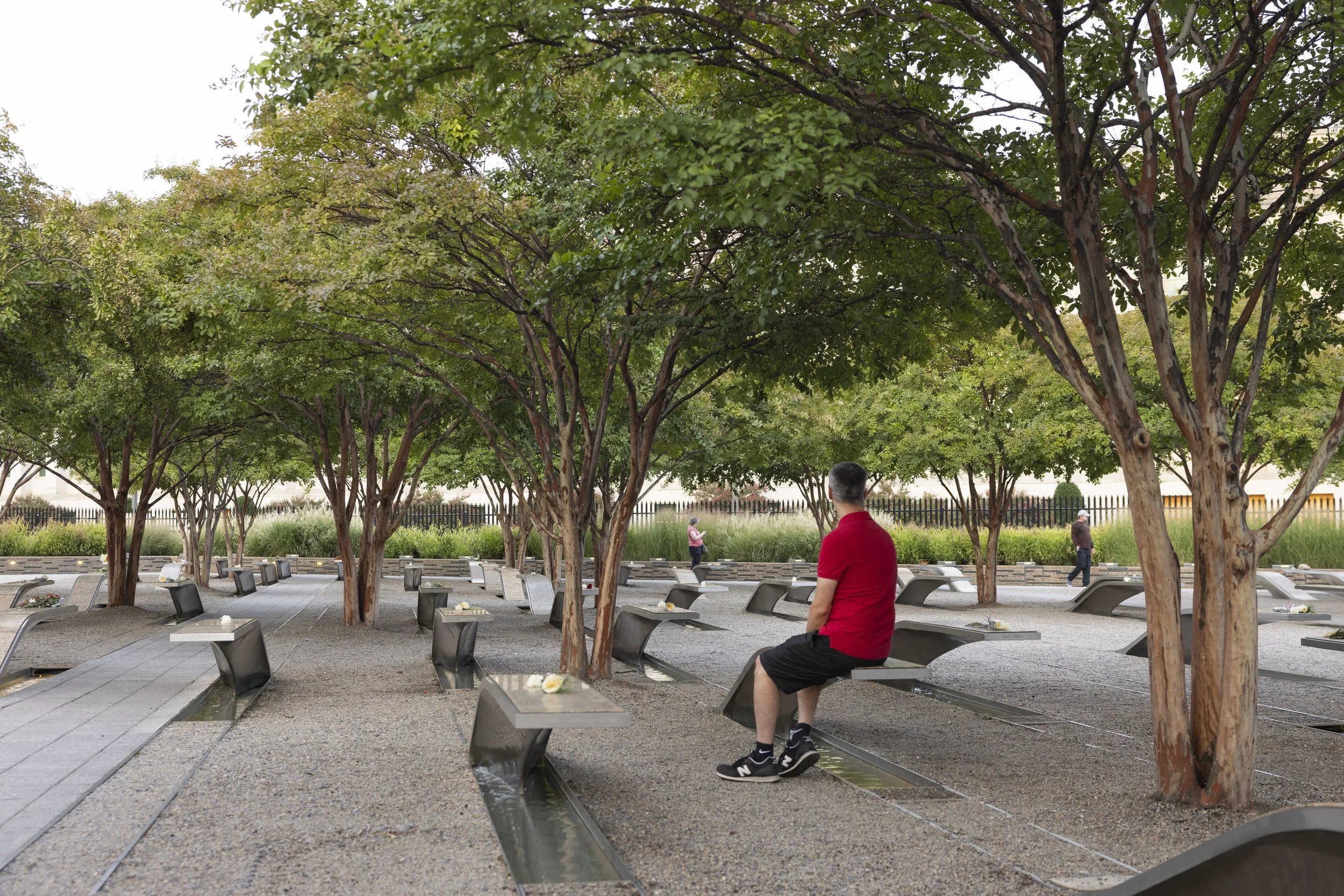 ARLINGTON, Va. — Visitors gather at the Pentagon Memorial on Sept. 11, 2026, the 25th anniversary of the 9/11 attacks. (Liz Helgesen)