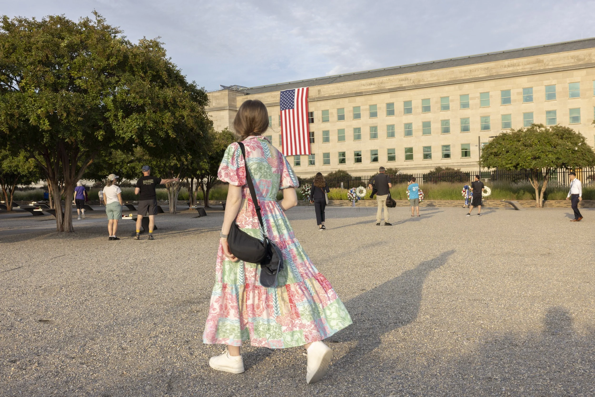 ARLINGTON, Va. — Visitors gather at the Pentagon Memorial on Sept. 11, 2026, the 25th anniversary of the 9/11 attacks. (Liz Helgesen)