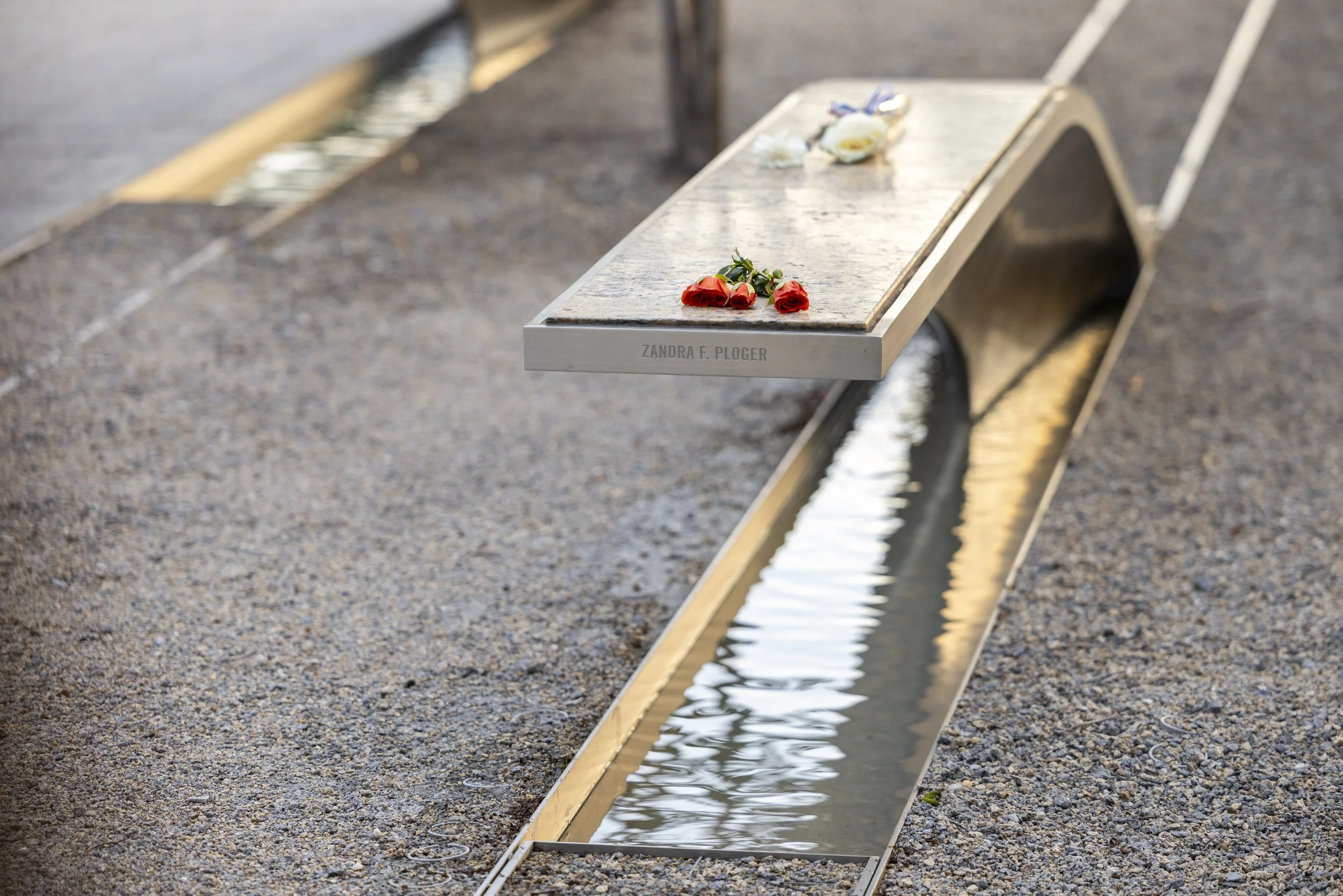 ARLINGTON, Va. — Flowers are left at the Pentagon Memorial in remembrance of the victims on Sept. 11, 2026, the 25th anniversary of the 9/11 attacks. (Liz Helgesen)
