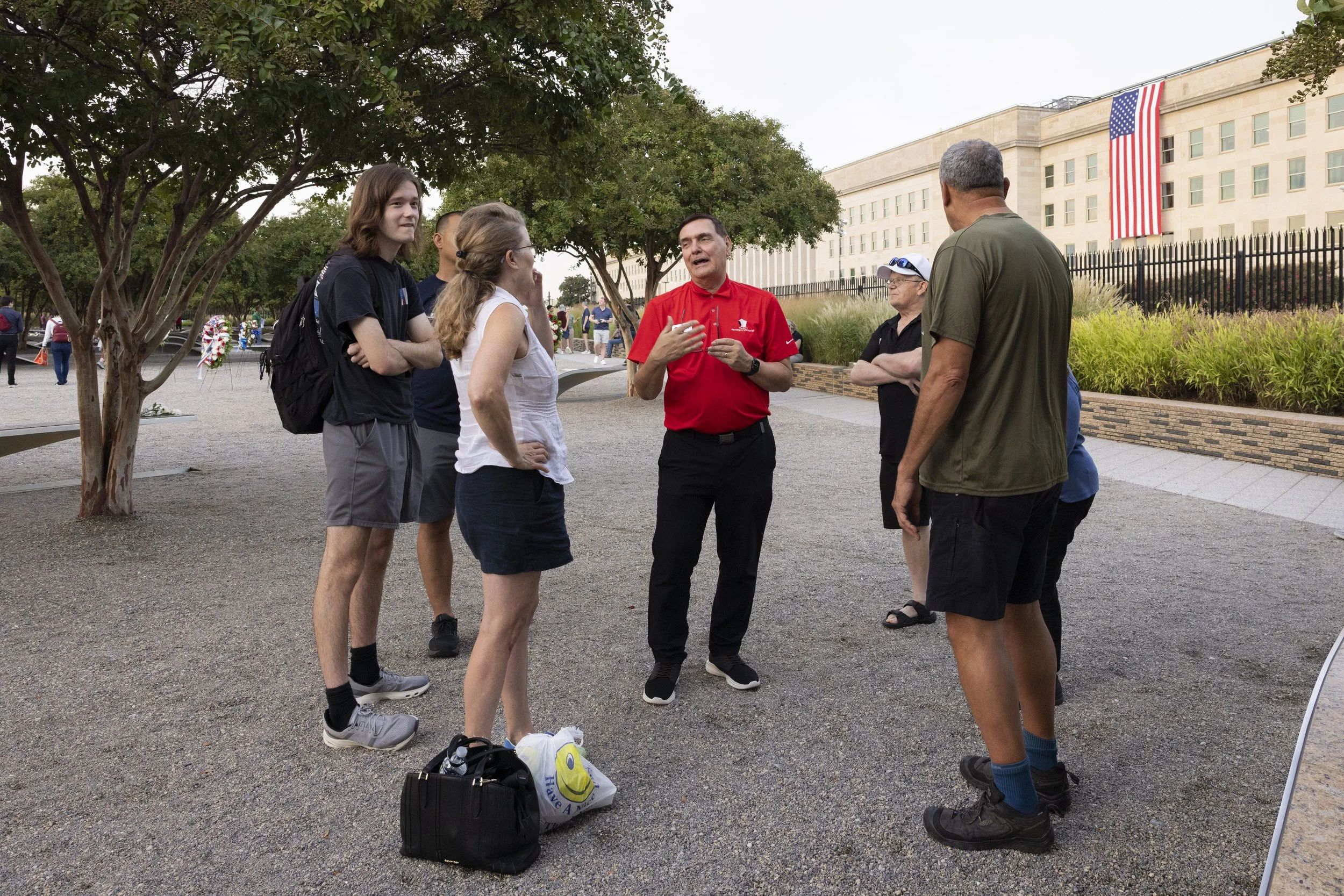 ARLINGTON, Va. — Volunteer docents from the Pentagon Memorial Fund answer visitors’ questions at the Pentagon Memorial on Sept. 11, 2026, the 25th anniversary of the 9/11 attacks. (Liz Helgesen)